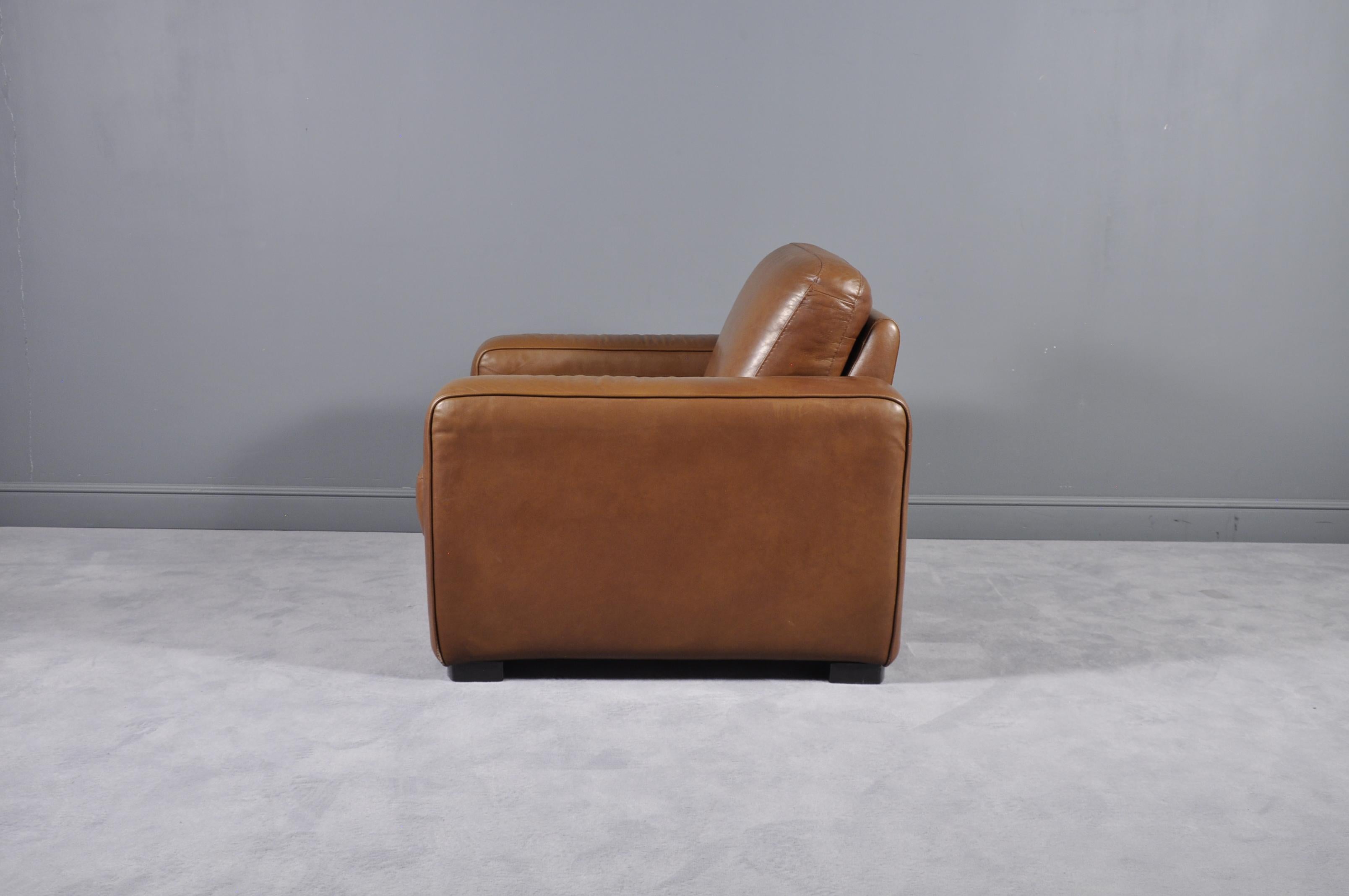 Large and comfy oversized leather club chair in a beautiful brown cigar leather. Features unique standing seams and exposed stitchwork. If you are looking for the perfect corner reading chair or a substitute to the generic recliner, this guy is it.