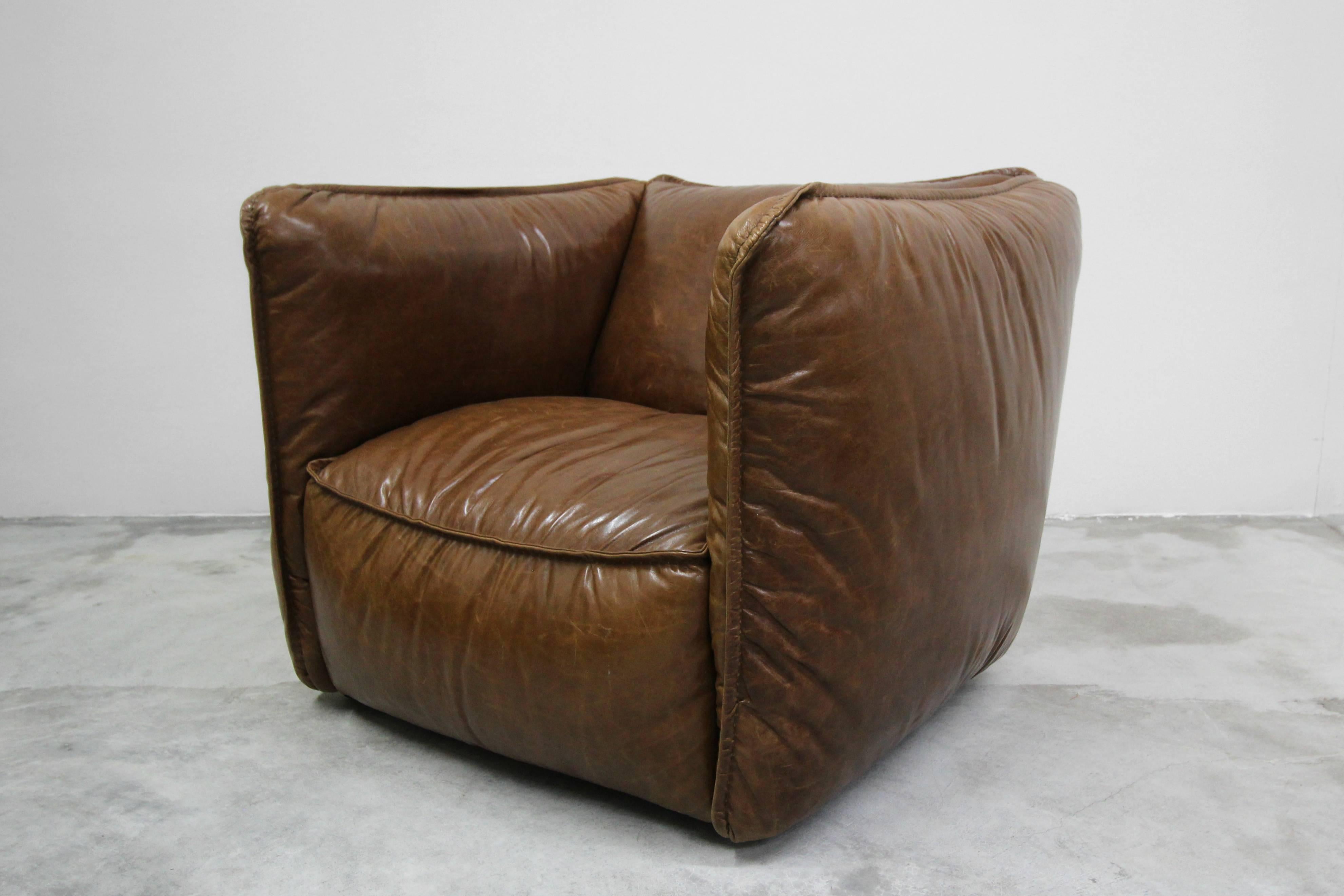 Large and comfy oversized leather club chair in a beautiful brown cigar leather. Features unique standing seams and exposed stitchwork. If you are looking for the perfect corner reading chair or a substitute to the generic recliner, this guy is it.