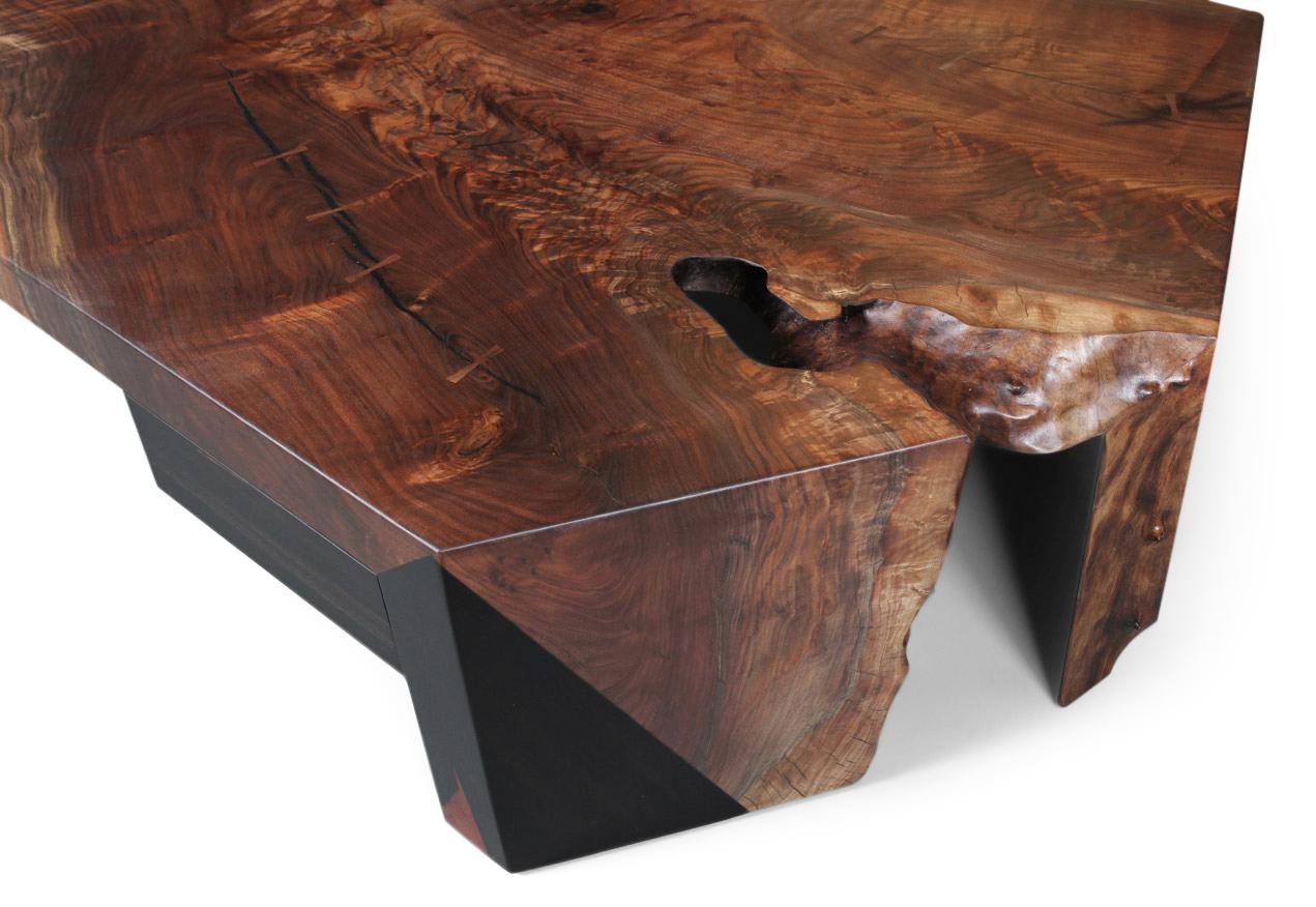 A single slab of figured Claro walnut fused with Macassar Ebony to create a waterfall effect over the ends of the table. An angled drawer crafted in spalted Maple and Macassar Ebony is tucked into one corner. The live edge is wildly organic and