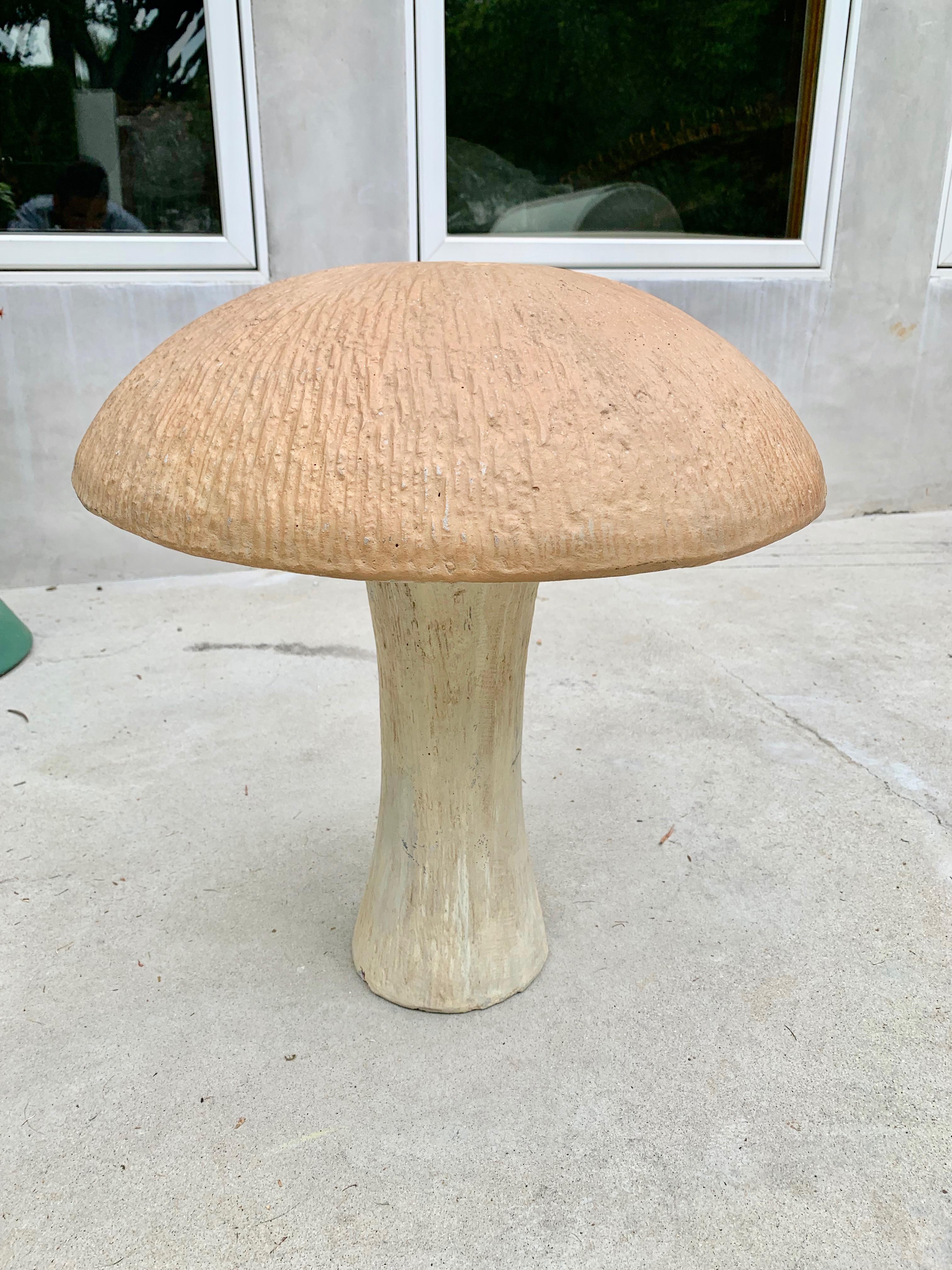 Large concrete mushroom sculpture from the 1970s. Light colored stalk with brown top. Can be used as a stool in the garden or placed inside or out as sculpture. Good vintage condition and coloring.