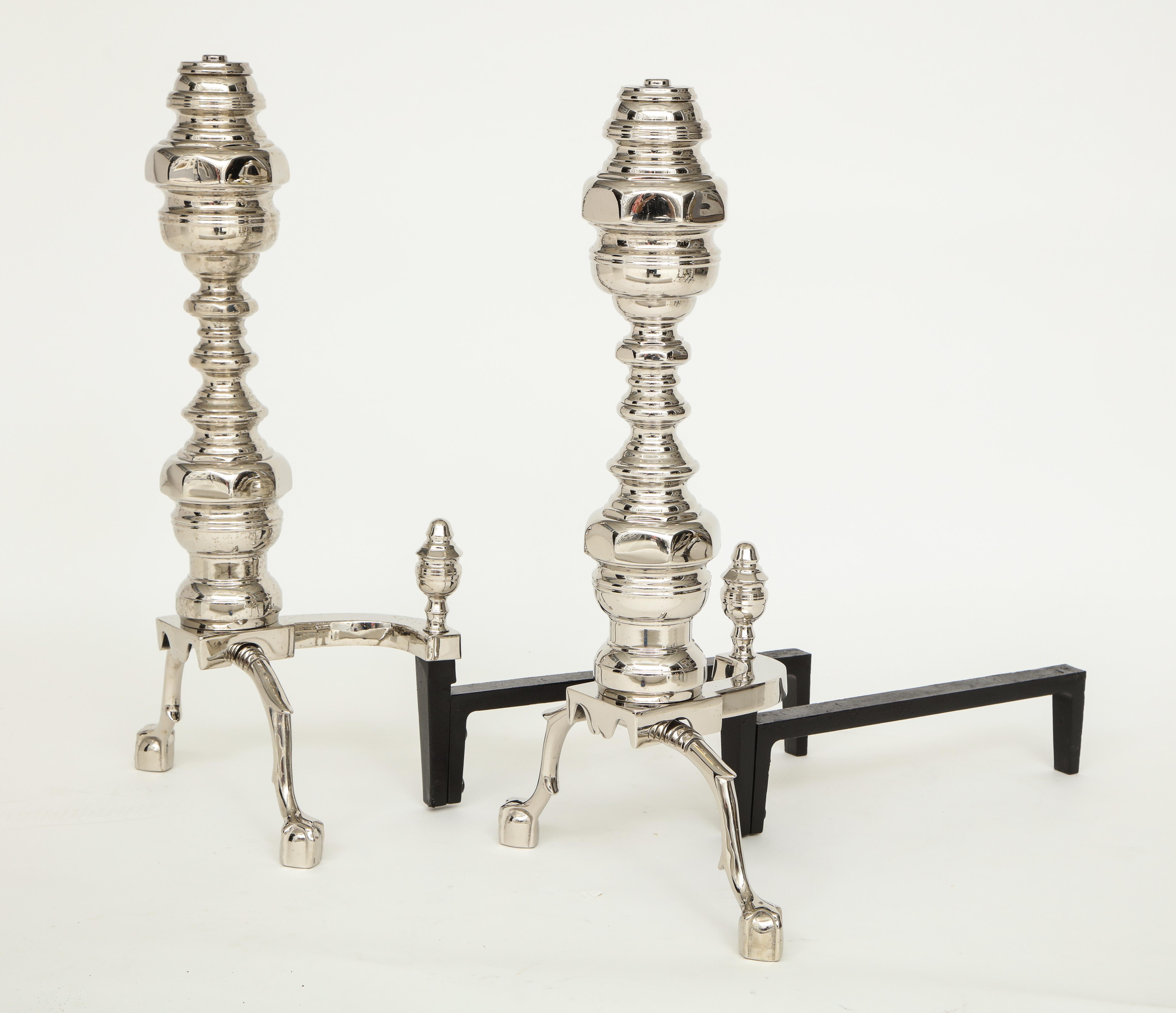 Pair of heavy engine turned andirons with traditional claw and ball feet, heavy iron backs. Great accent pieces for traditional to modern homes.