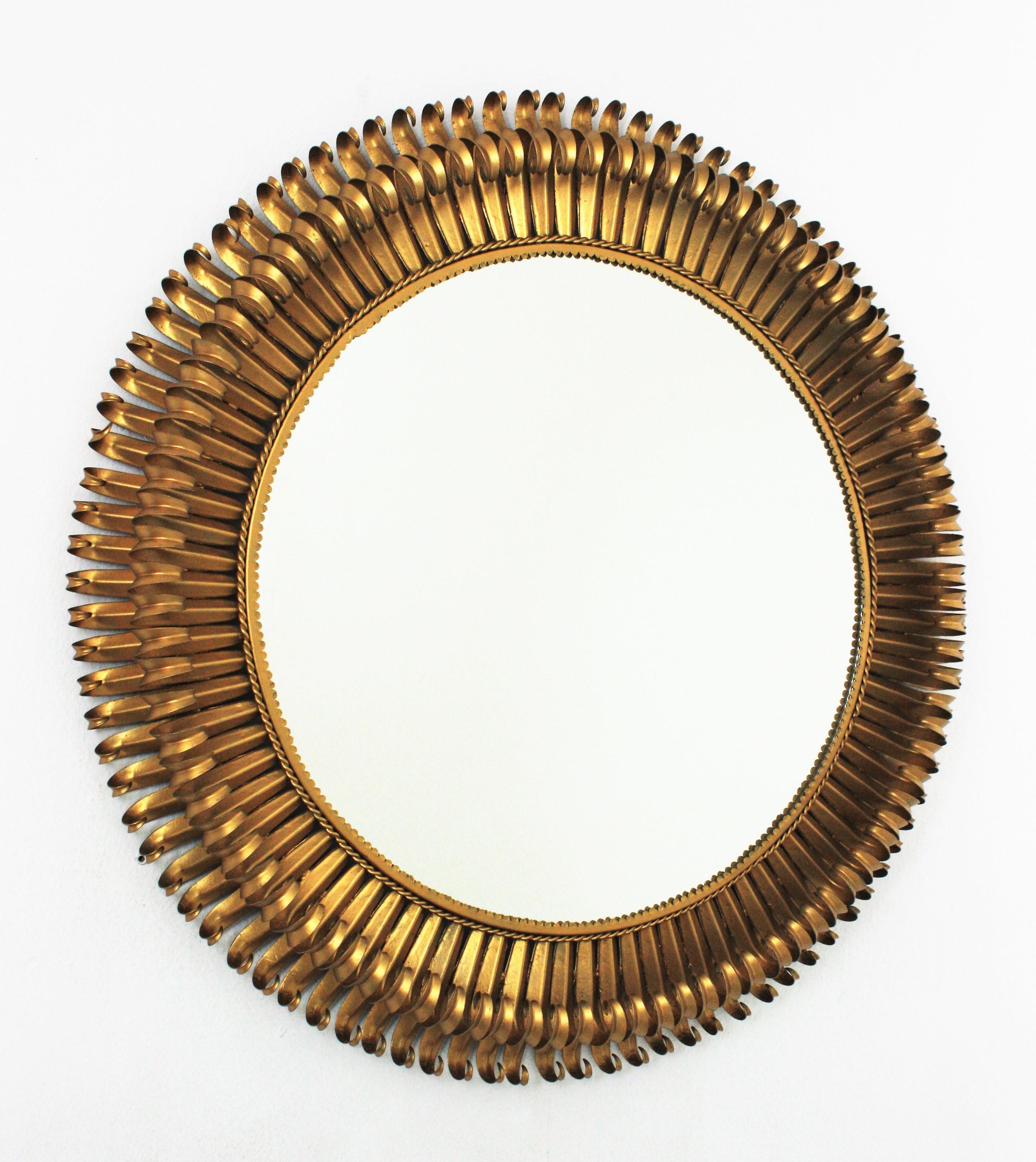 Frech Oversized Sunburst Mirror, Gilt Iron
Massive double layered eyelash gilt wrought  iron sunburst mirror, France, 1950s
The frame is made by a double layer of curved beams in eyelash shape.
This is one of the larger examples of this type of