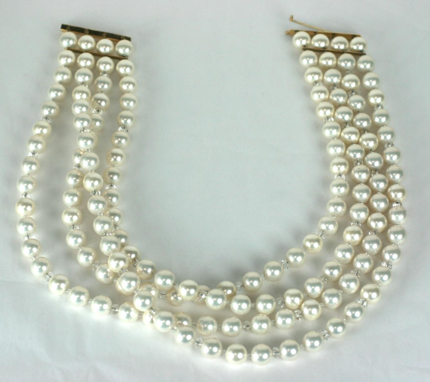 Oversized Faux Pearl and Gold Collar from the 1980's. Custom made necklace with 4 strands of oversized 10mm faux pearls (which are quite weighty as they are likely mother of pearl beads with a nacre coating). 
These pearl beads are all strung with