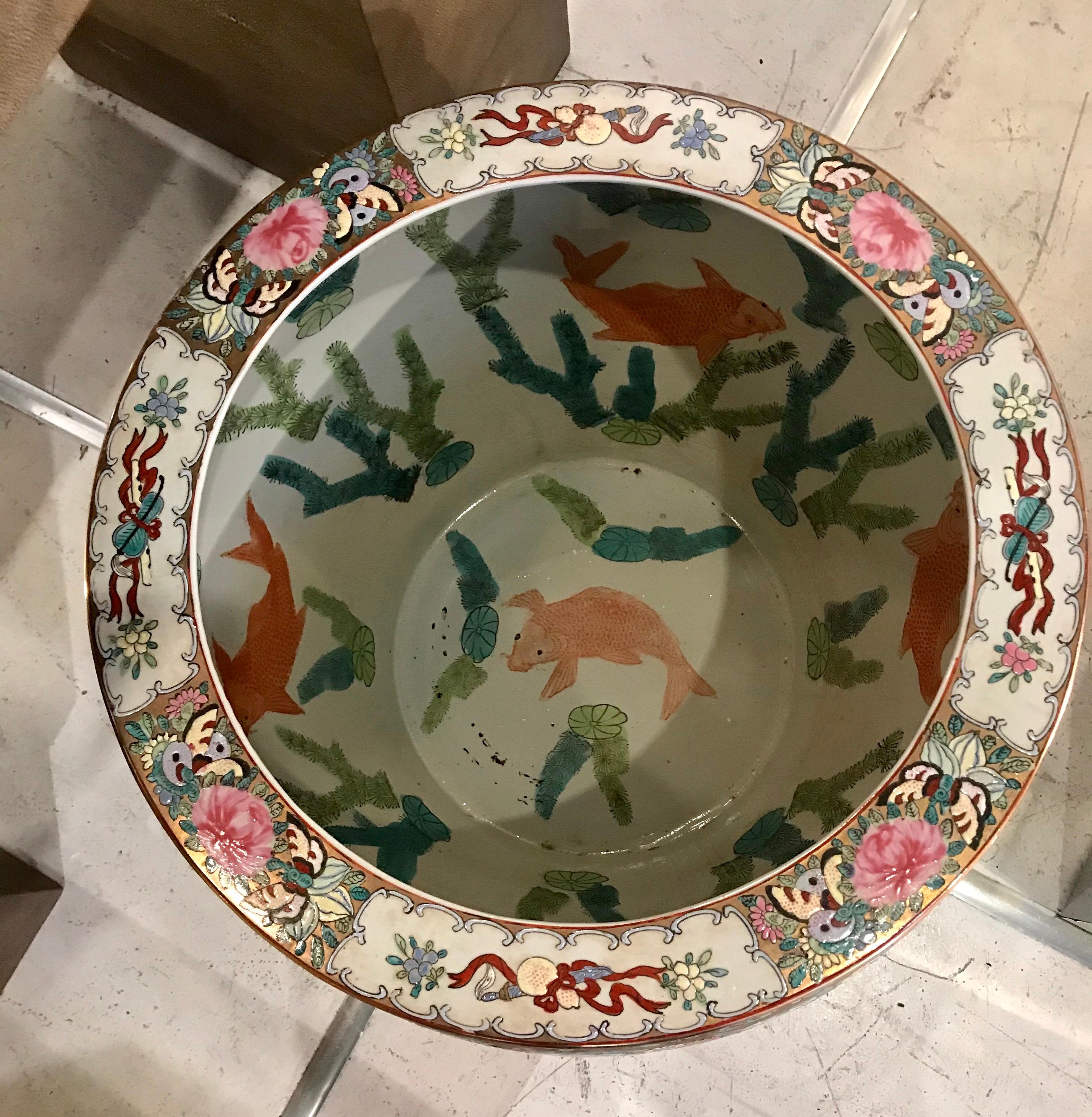 Beautiful enameled ceramic oversized chinoiserie planter/jardinière with koi fish interior motif and wooden stand.