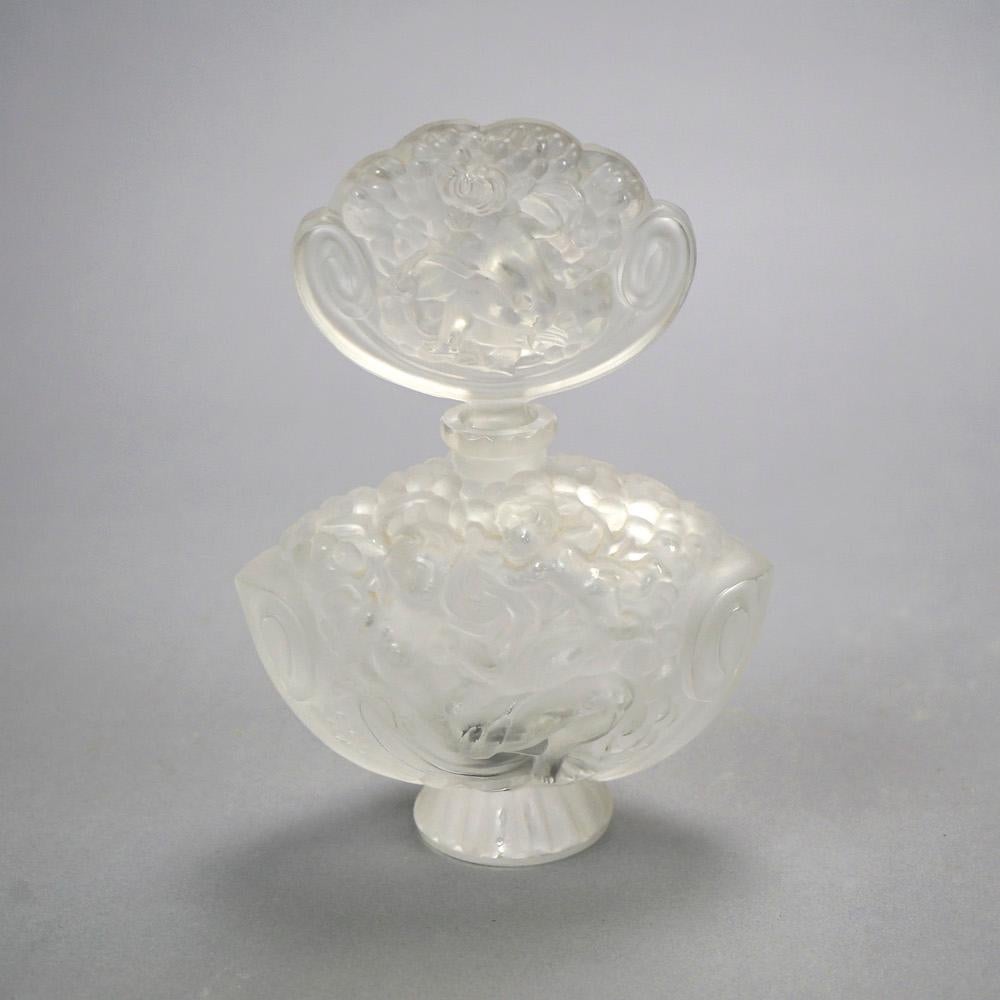A French perfume bottle by Lalique offers frosted glass construction with figures , foliate end floral elements in relief, maker mark on base as photographed, 20th C

Measures- 8''H x 5.5''W x 3''D.