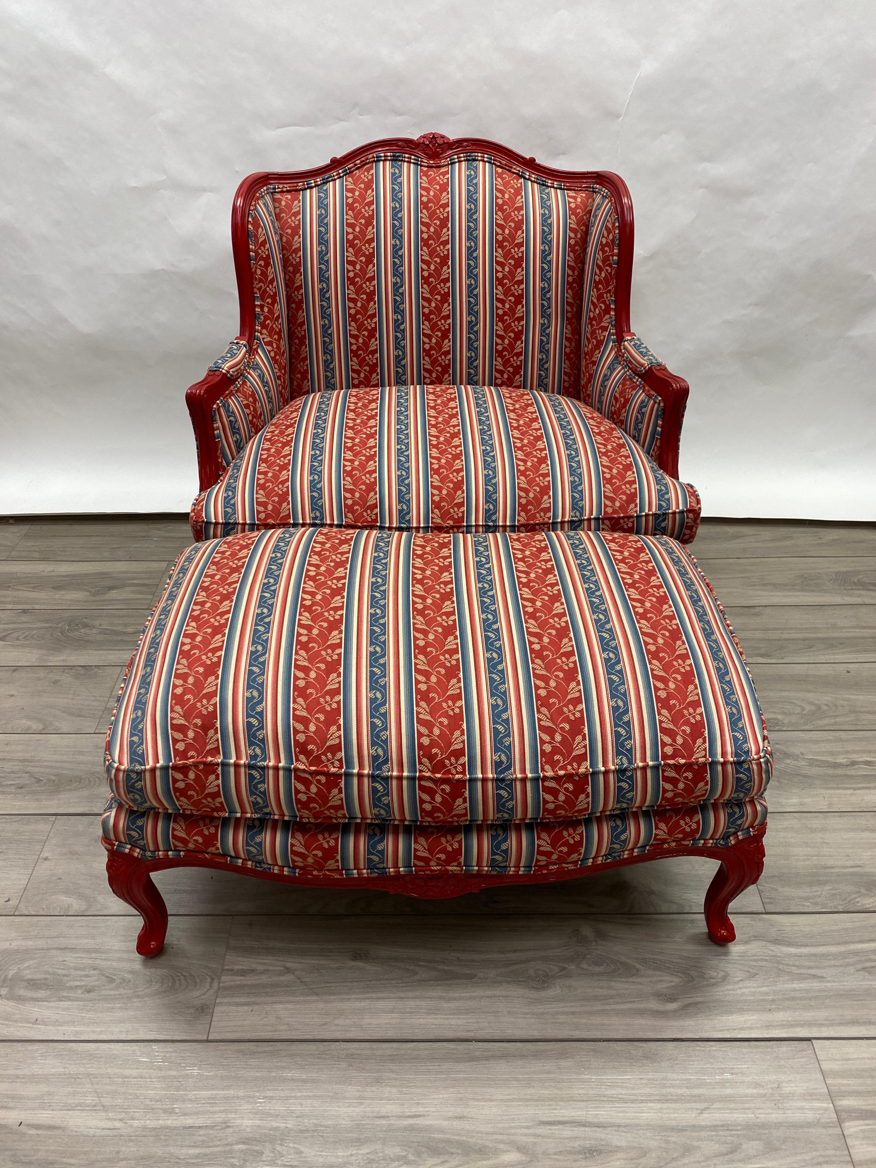 This is a stunning oversized French Louis XV style Bergere with the matching ottoman carved from oak. The chair has a gorgeous Royal French Red Gloss Lacquer paint finish which we have recently touched up. The down-filled upholstery is in excellent