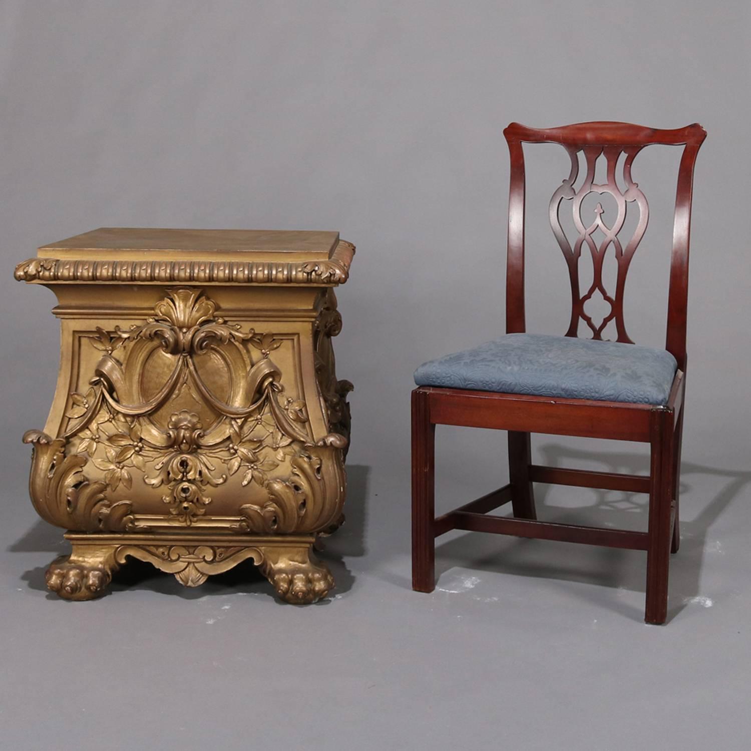 Pair of French style oversized Hollywood Regency end tables by Daprato Statuary Co. feature Bombe form gilt finished cast composite construction with high relief scroll, acanthus and foliate decoration and seated on paw feet, originally statuary