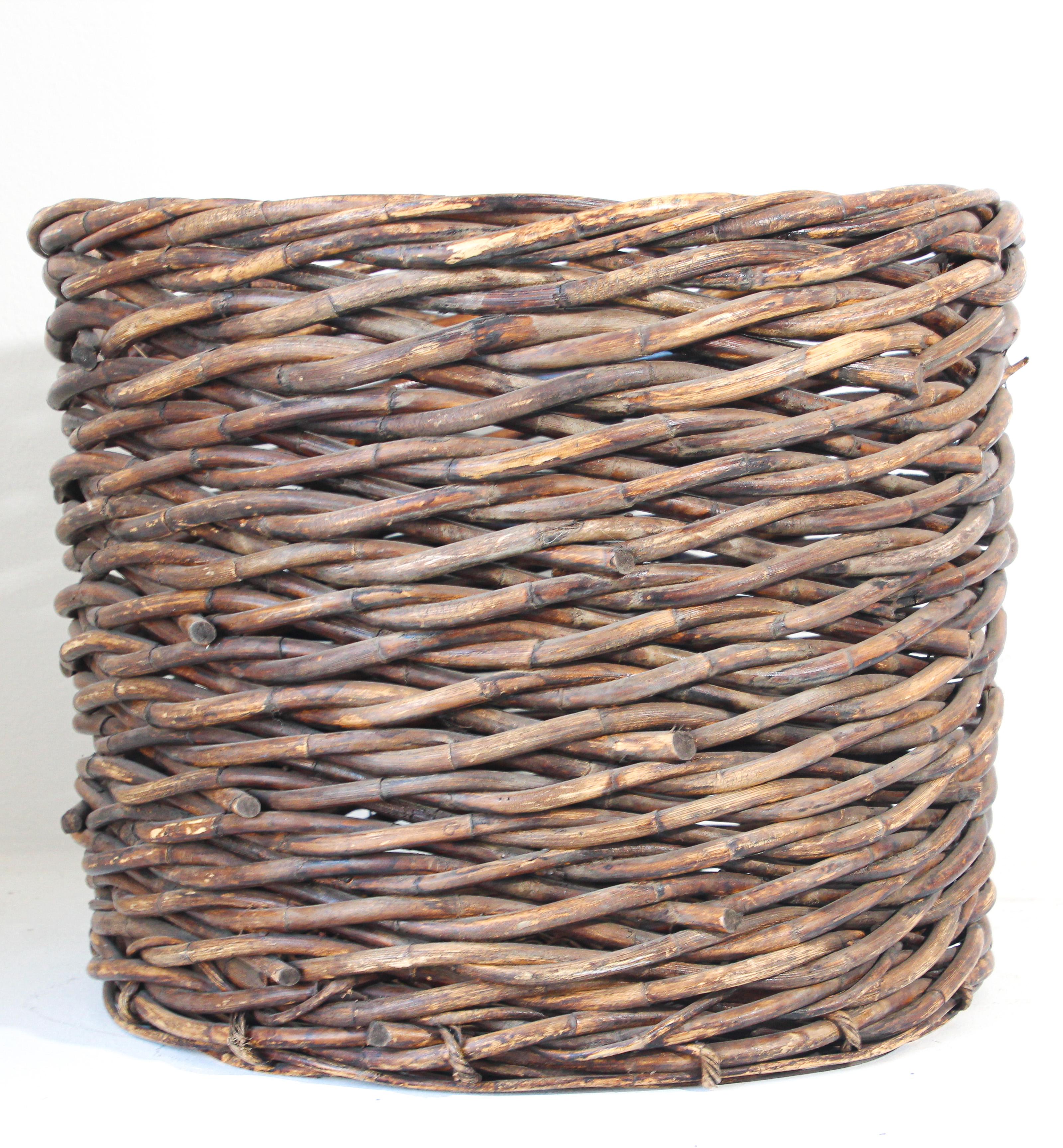 Large oversized French vineyard harvest wicker basket.
Classic oversized French wicker basket.
Handmade and Handwoven of a thick wicker in superb condition and a lovely warm patina. 
Art and crafts rustic style for your country barn house.
Great