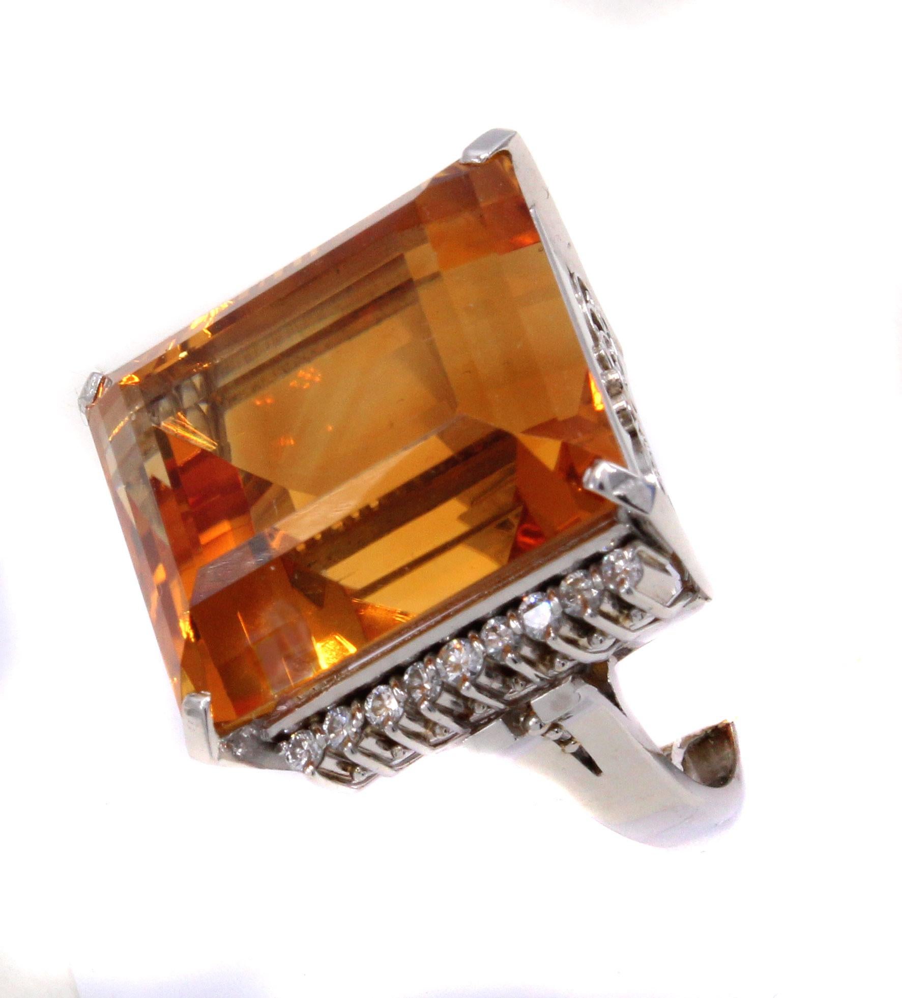 This bold and unique ring from the 1960s features a gem emerald cut Golden Citrine measured to weigh approximately 37.50 carats. The Citrine exhibits an amazing saturation of color and the perfect cut brings out an incredible amount of fire and