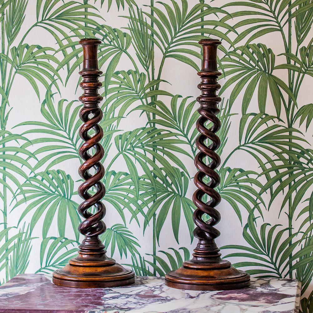fine and very unusual large pair of English open barley twist candle sticks. The candle sticks of extraordinary Size with a beautiful dark brown patination throughout. Having round bases with stepped design and long open barley twist type stems