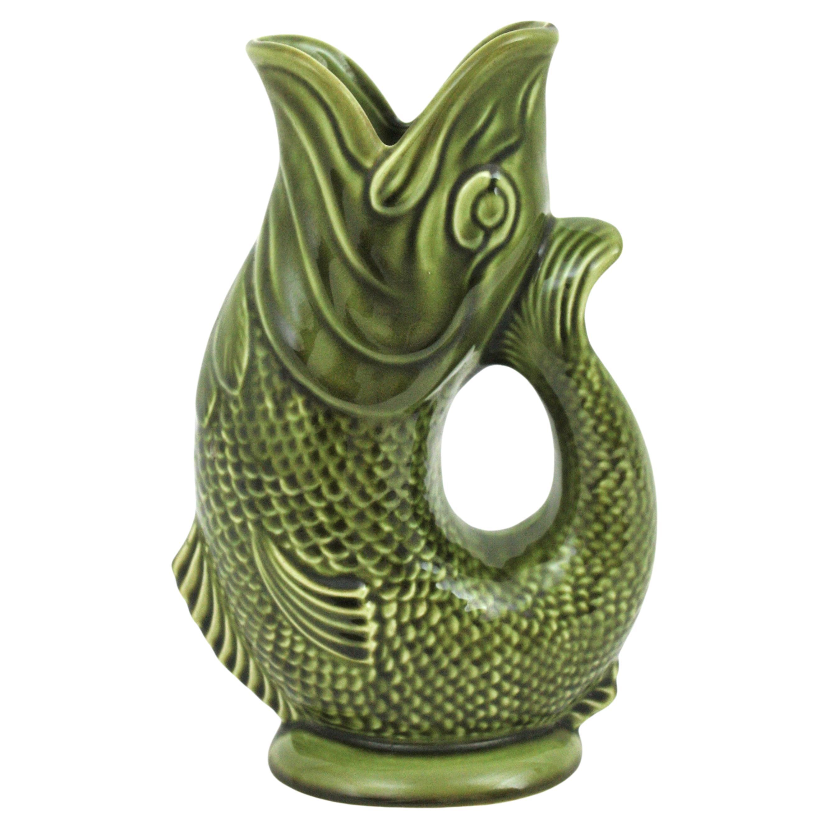 Oversized Mid-Century Modernist glazed ceramic gurgling fish water jug / pitcher. England, 1950s-1960s
Manufactured by Dartmouth Devon England.
Eye-catching large green Majolica ceramic vase, fish glug jug or pitcher.
This fish jug vase will be a