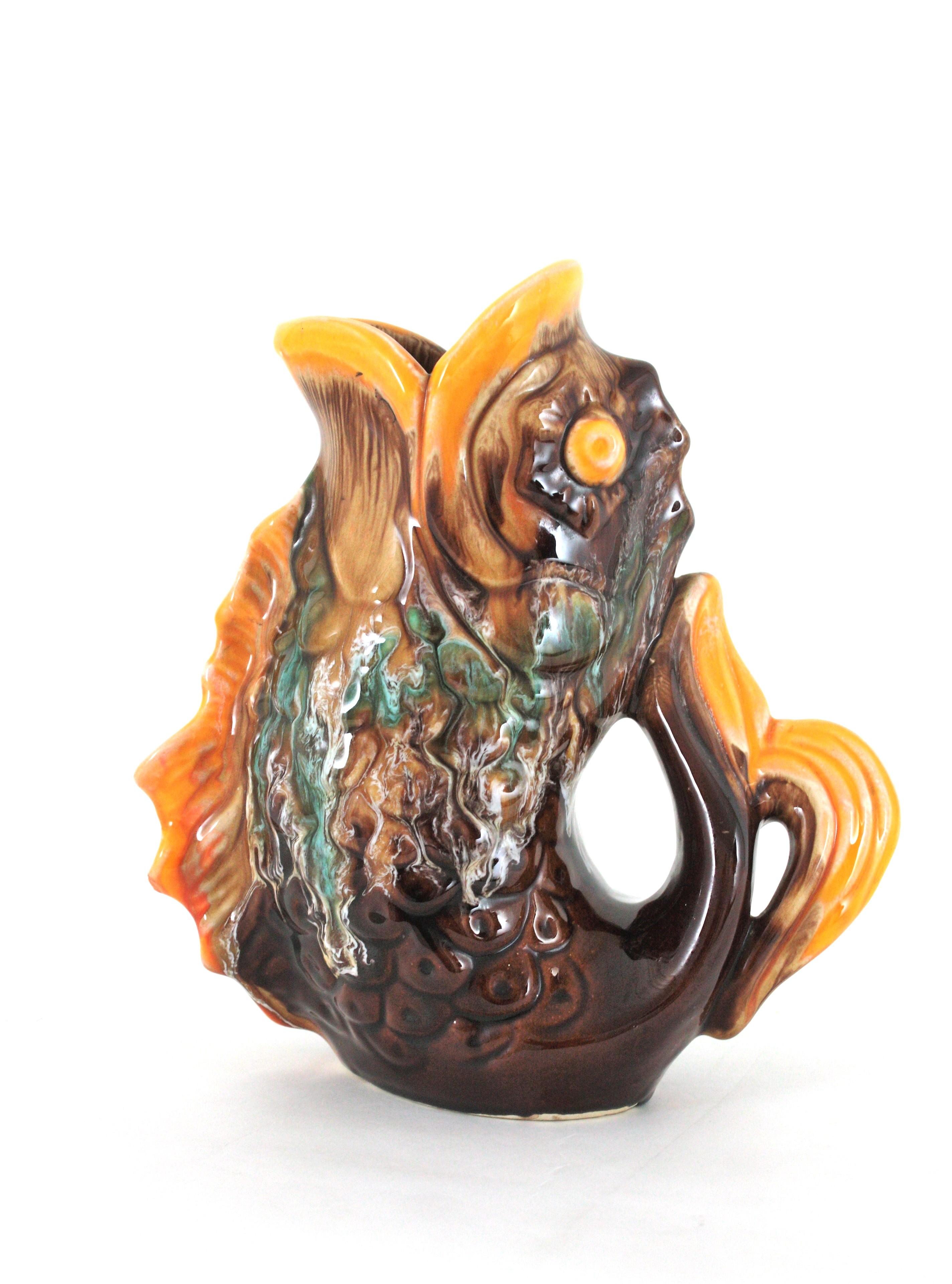 Oversized Mid-Century Modernist glazed ceramic gurgling fish water jug / pitcher. France, 1950s-1960s
Manufactured by Vallauris Ceramics.
Eye-catching large green Majolica ceramic vase, fish glug jug or pitcher.
This fish jug vase will be a nice
