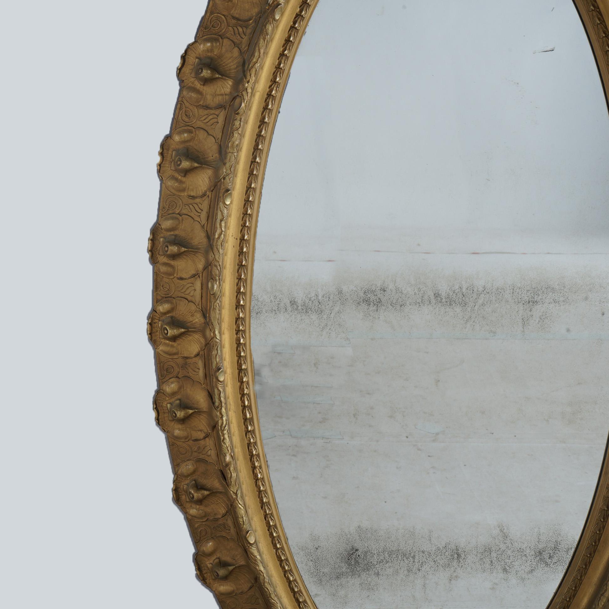 XIX secolo Specchio ovale da salotto in legno dorato sovradimensionato con stemma floreale e fogliame C1890 in vendita
