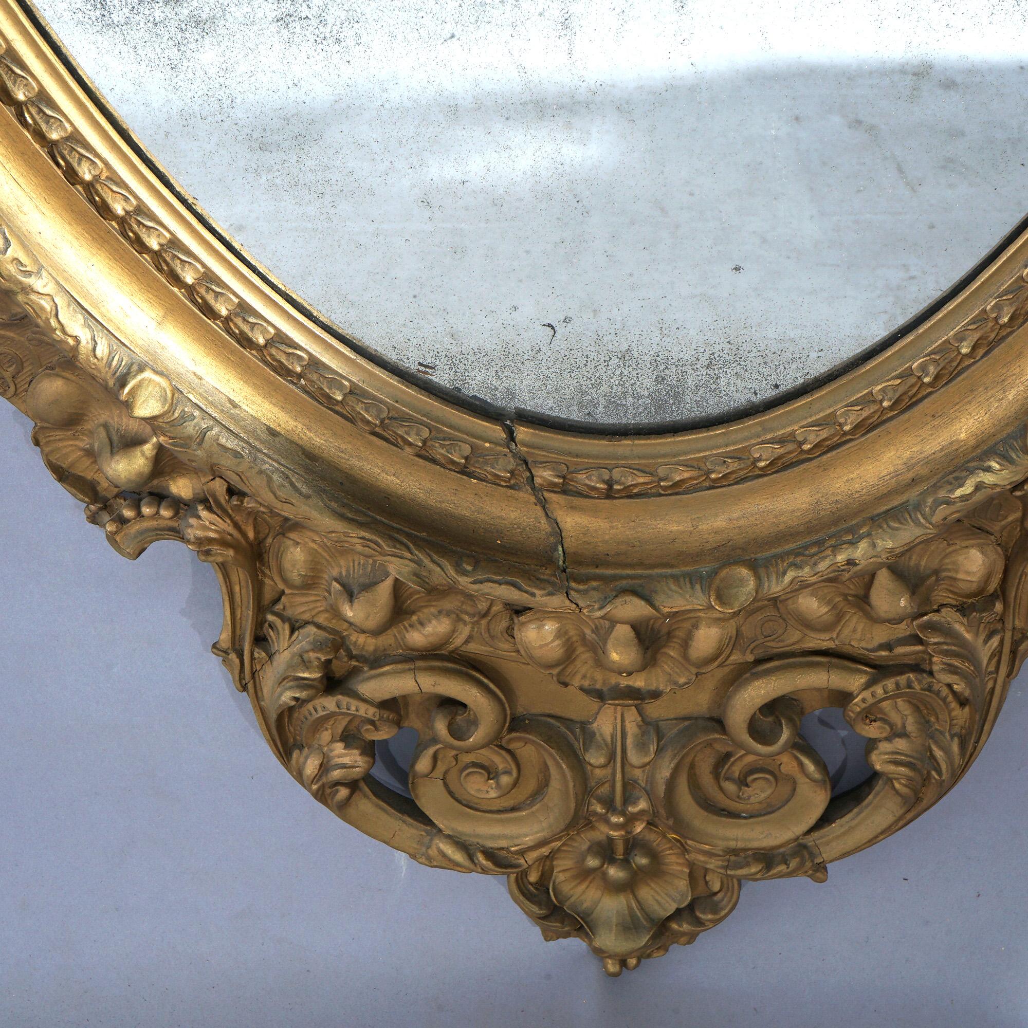 Specchio ovale da salotto in legno dorato sovradimensionato con stemma floreale e fogliame C1890 in vendita 3