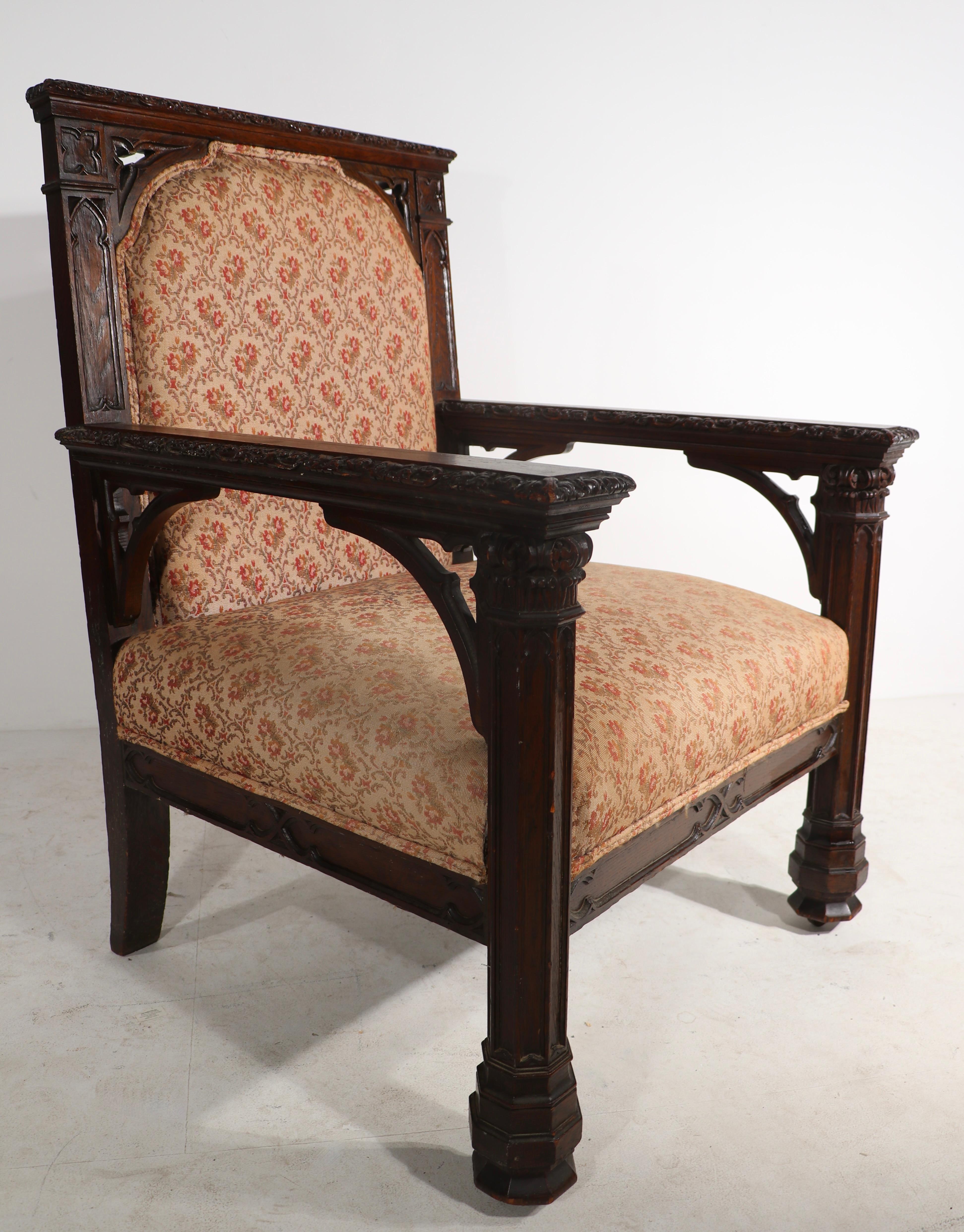 Fabulous over-scale Gothic Revial throne style arm chair-in carved oak, with (re upholstered) seat and backrest. 
This example is in very good original condition showing only light cosmetic wear normal and consistent with age.
Carved wood, well