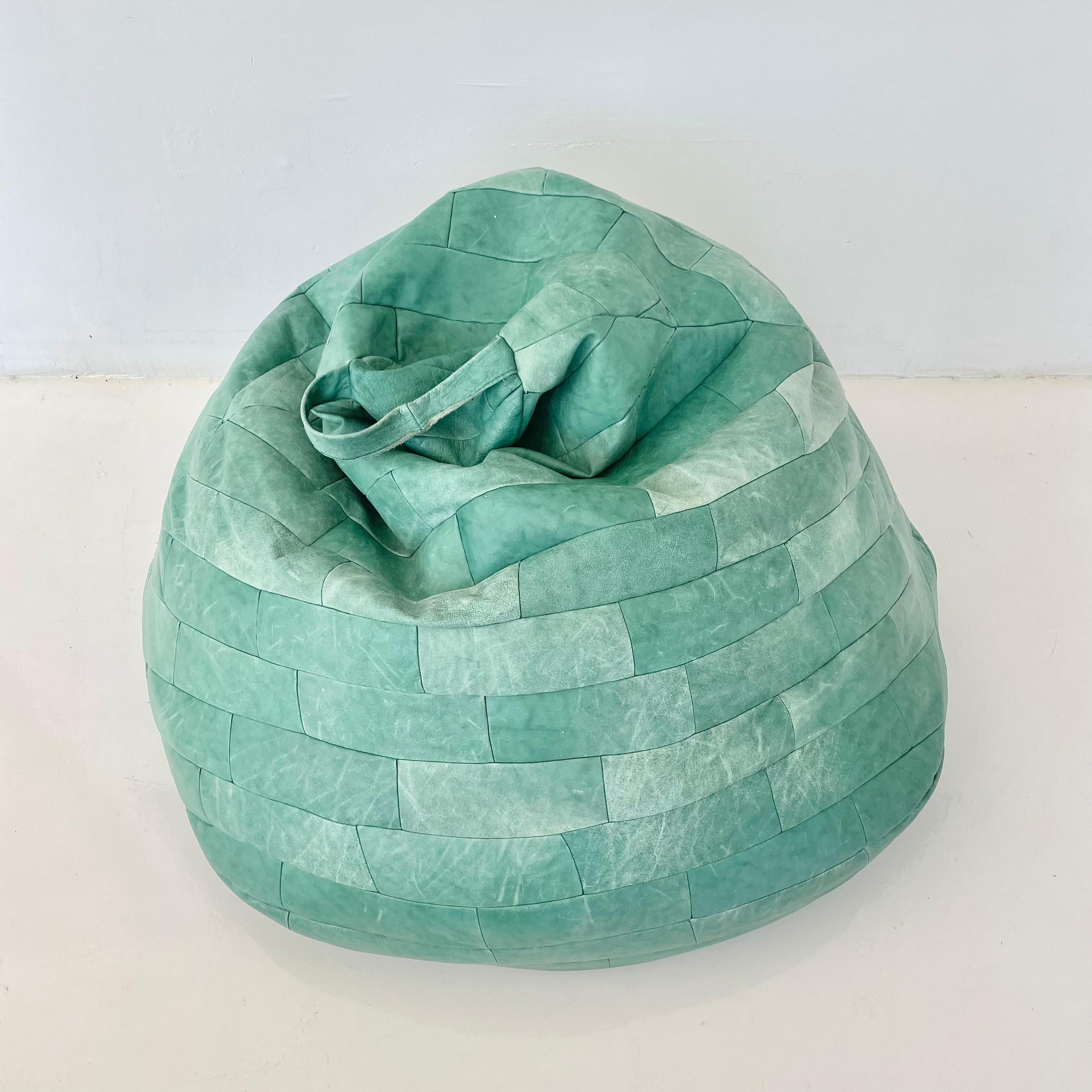 Gorgeous oversized 70s powder green leather patchwork bean bag by De Sede. Great coloring and patina to leather. Good vintage condition. Wear to leather as shown. Extremely comfortable. Fun accent piece.

Newly stuffed with foam beads and slip