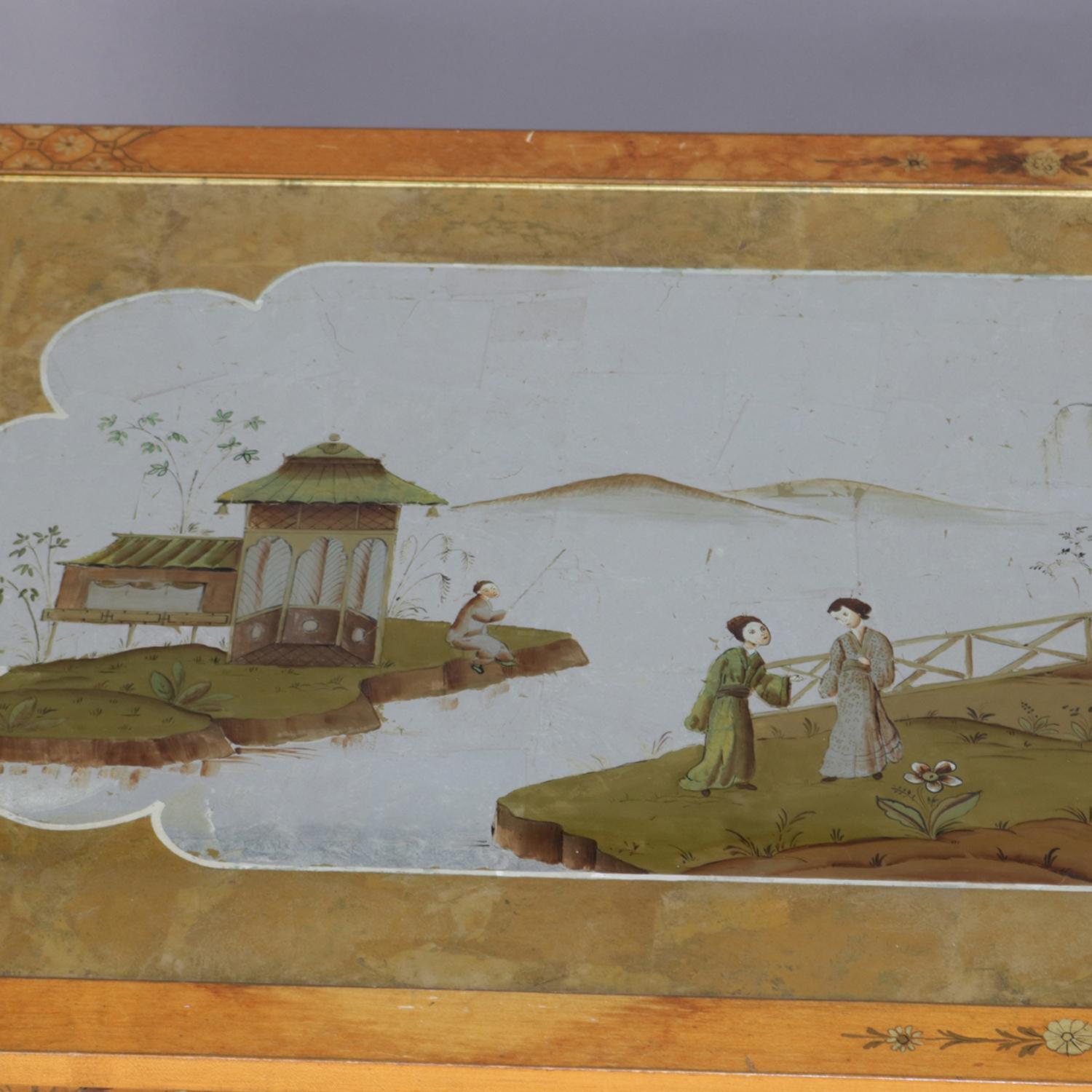 Oversized pictorial Chinoiserie coffee low table features hand painted top of lake scene with figures, pagoda and mountainous background, frame is gilt decorated throughout, circa 1940

Measures: 18