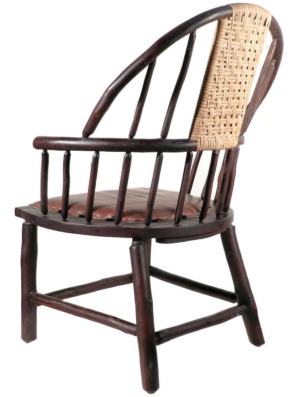 This grand country old hickory Windsor chair is a beautiful combination of hickory, rattan and leather. It was created and signed by Flat Rock Furniture and is their oversized custom 061 Windsor chair. They are the very high end of Adirondack Old