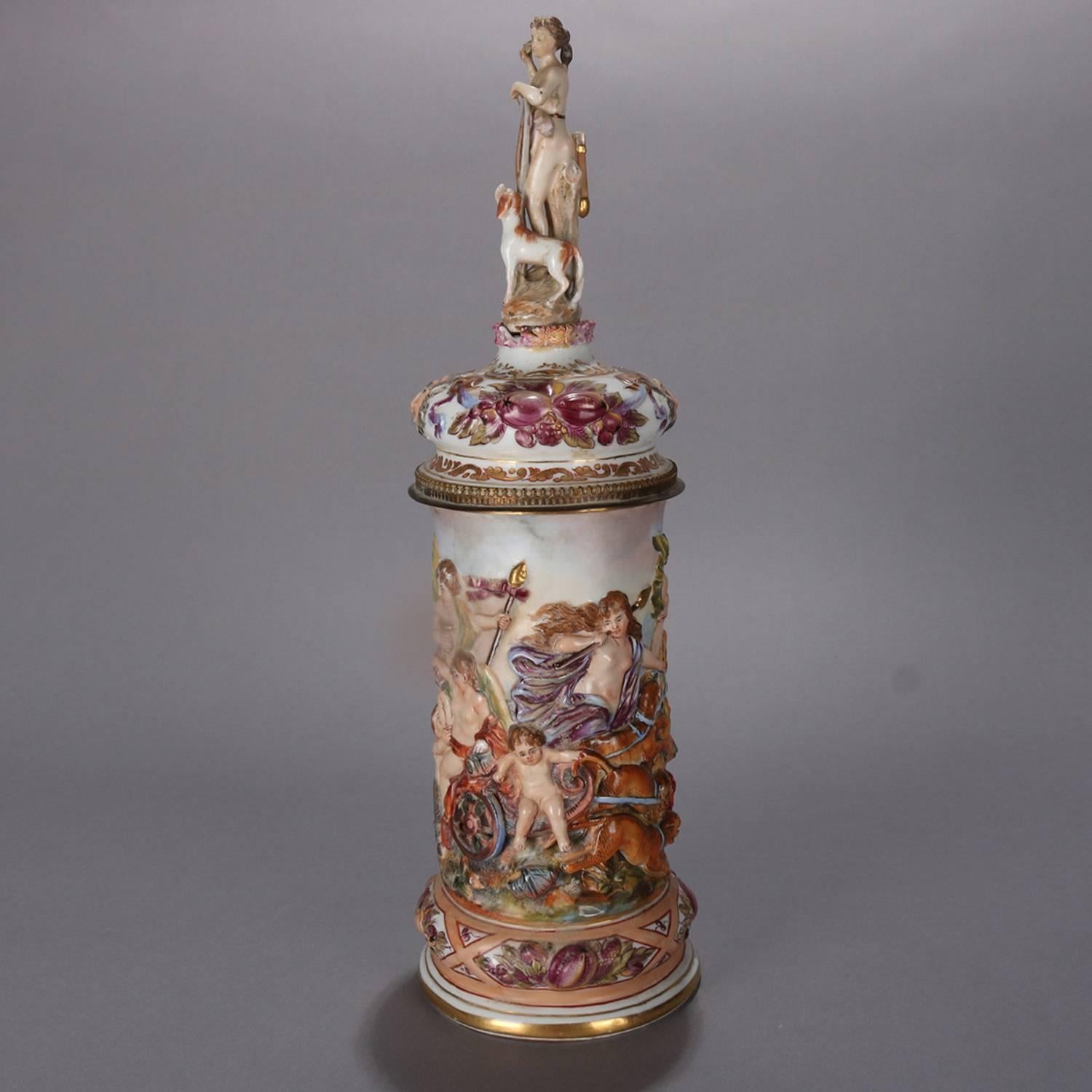 Oversized Italian Continental School high relief porcelain stein features high relief and hand-painted Classical scene with heavy gilt highlights, handle with mask and cast bronze eagle hinge, lid with figural finial, blue crown 