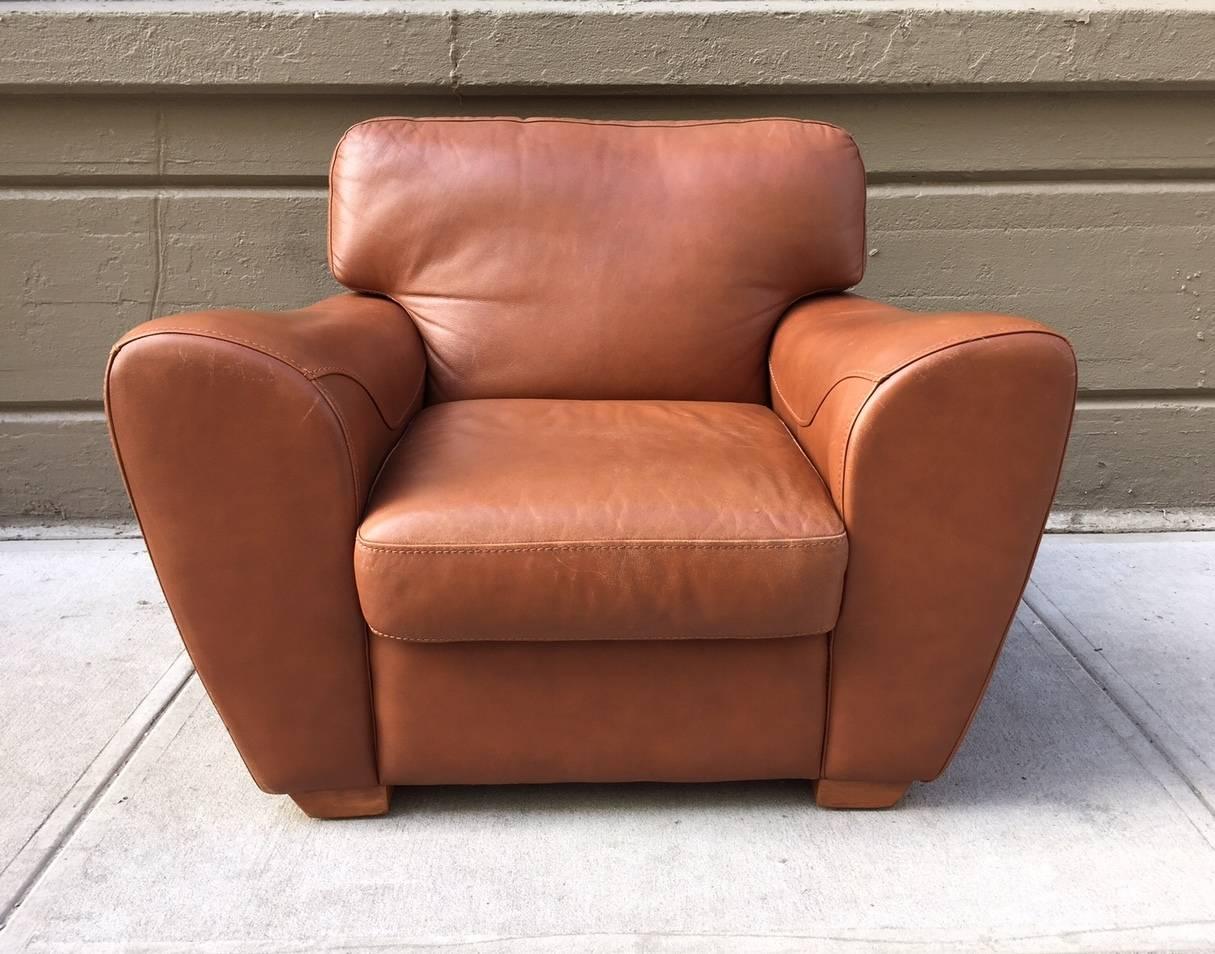 Oversized Italian leather lounge chair has wooden base with nice stitch work.