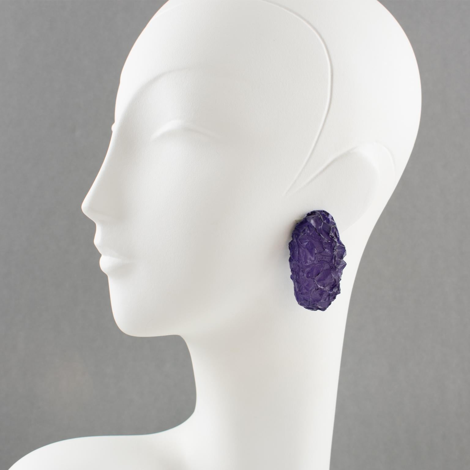 Stylish oversized carved Lucite or resin clip-on earrings from an Italian design studio. Dimensional ovoid shape with rock carving in frosted deep purple color, textured surface with wrinkles. Very unusual shape. No visible maker's