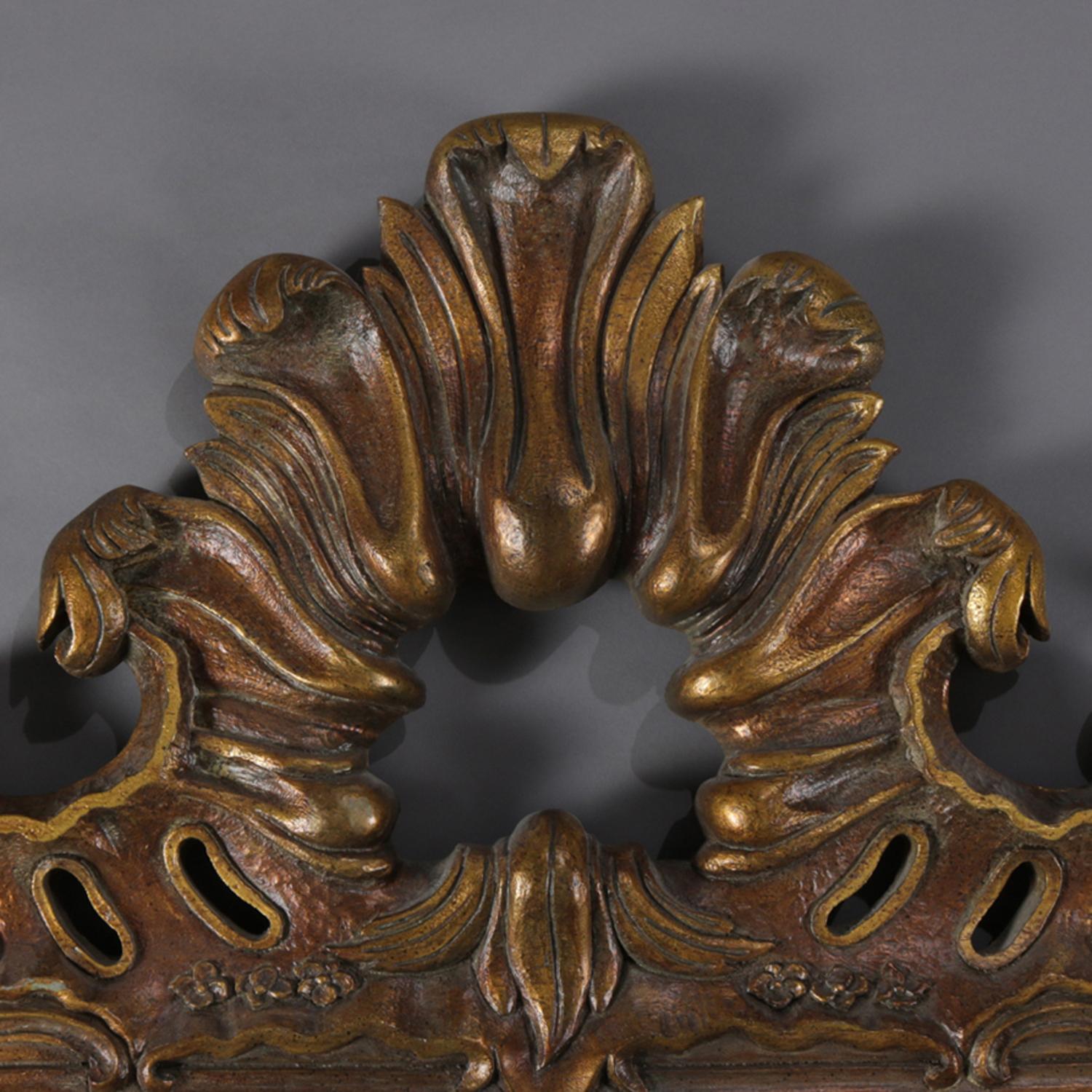 Oversized Italian Rococo overmantel wall mirror features foliate form with pierced and gadroon crest and C-scroll and gadroon corners, 20th century


Measures: 60