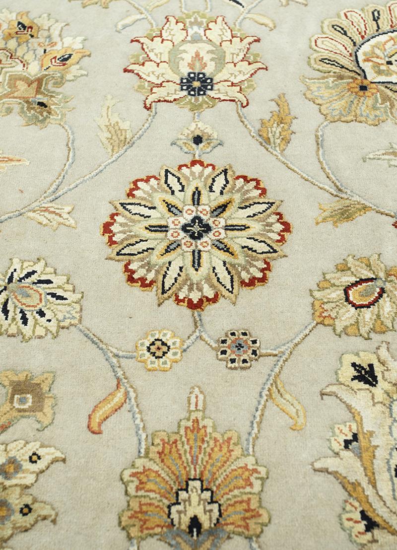 A beautiful oversized contemporary design carpet, hand knotted using finest wool and Chinese mulberry silk. On a light grey field, the design of Lotus blossoms standing next to each other executed in gold, silver and green tones. The light