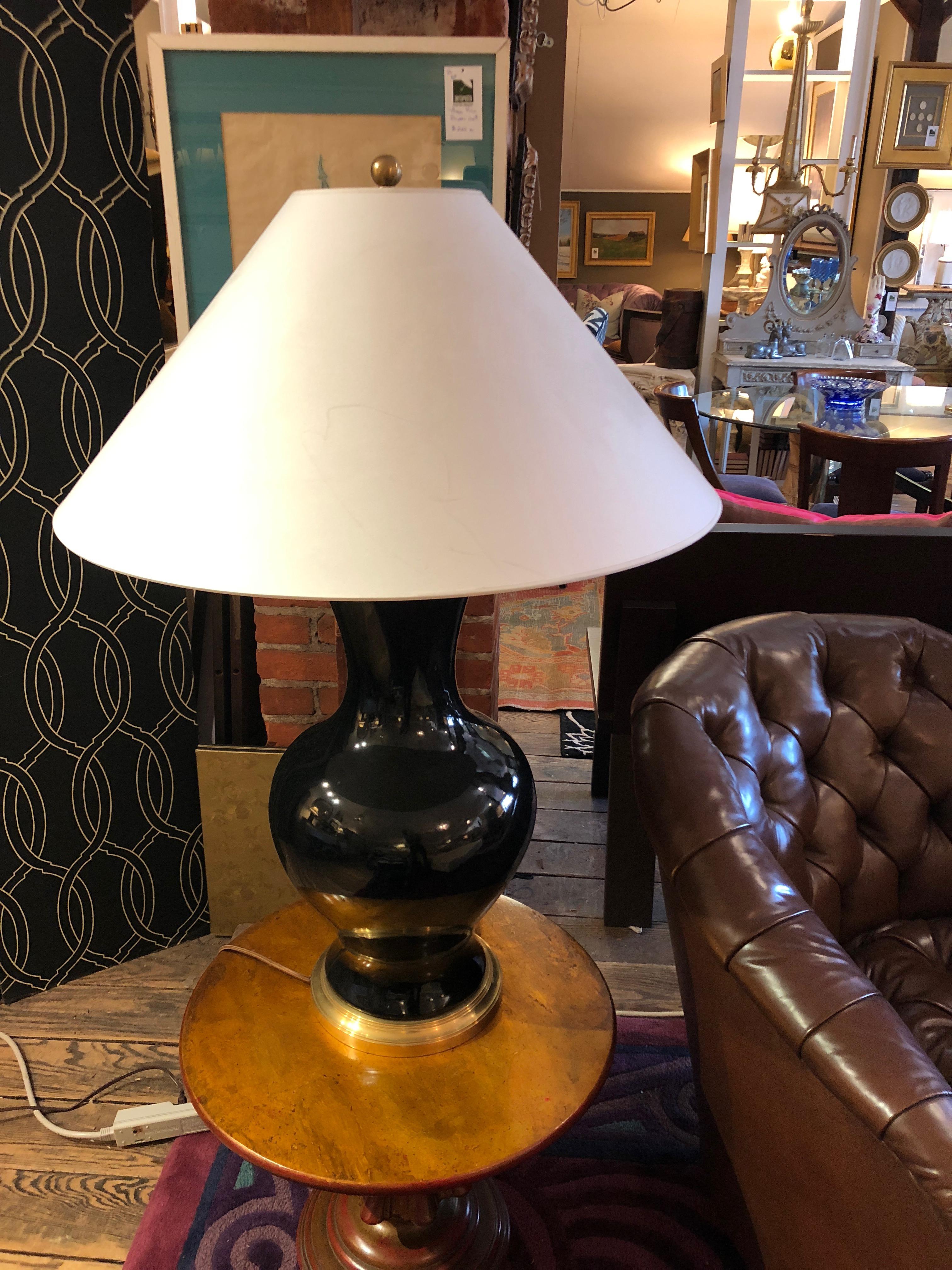 A statement lamp for its impressive size having a shiny black vase shaped base with brass accents and a huge custom paper shade.
The vase is 26 inches height x 12 inches diameter.
