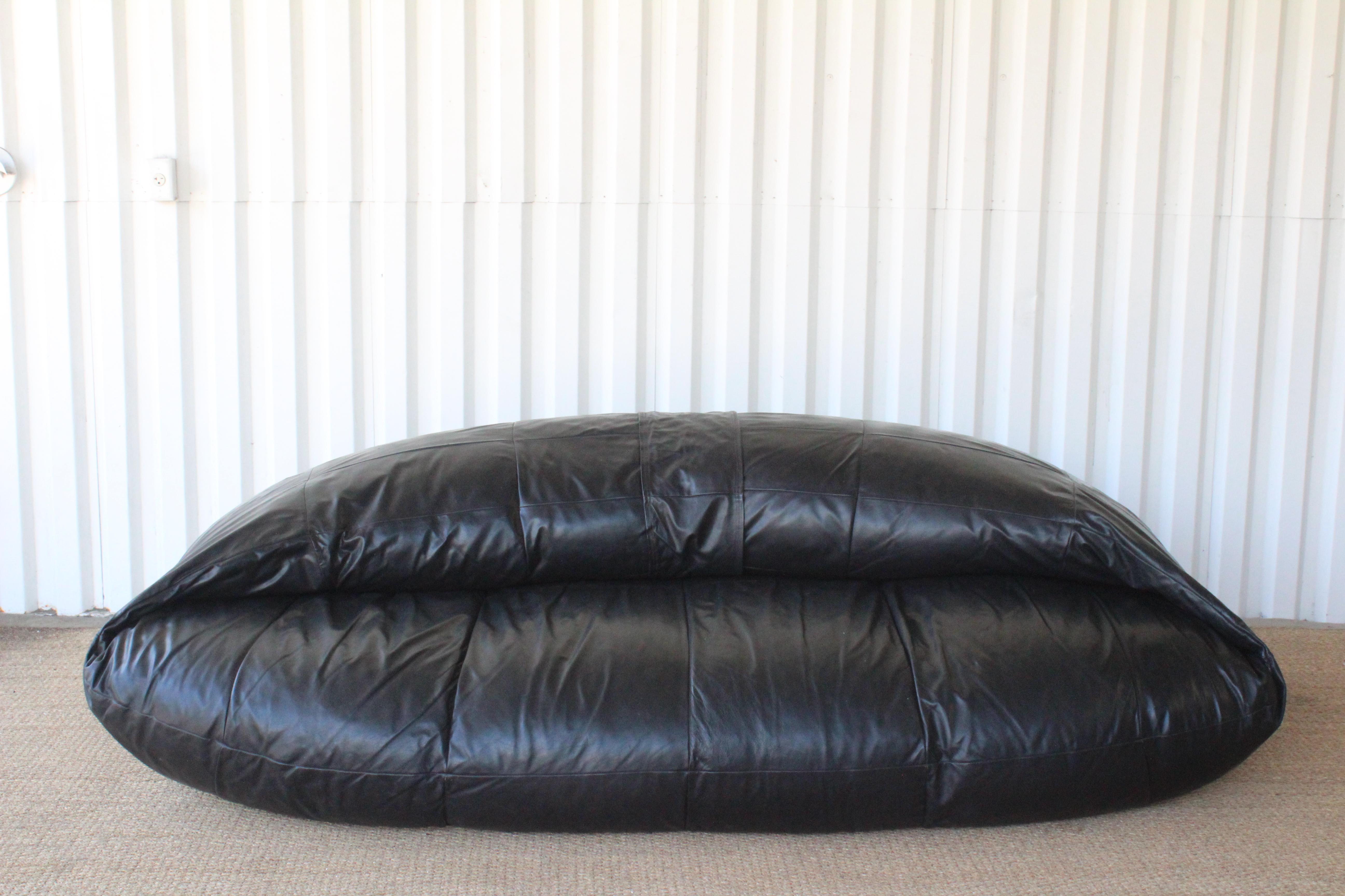 Large, over sized vintage bean-bag sofa in black leather. Most likely Italian- 1970s. In over all good condition with some minor wear to the leather like small nicks and spots but no tears or rips. Offers a low- lounge like seat setting.