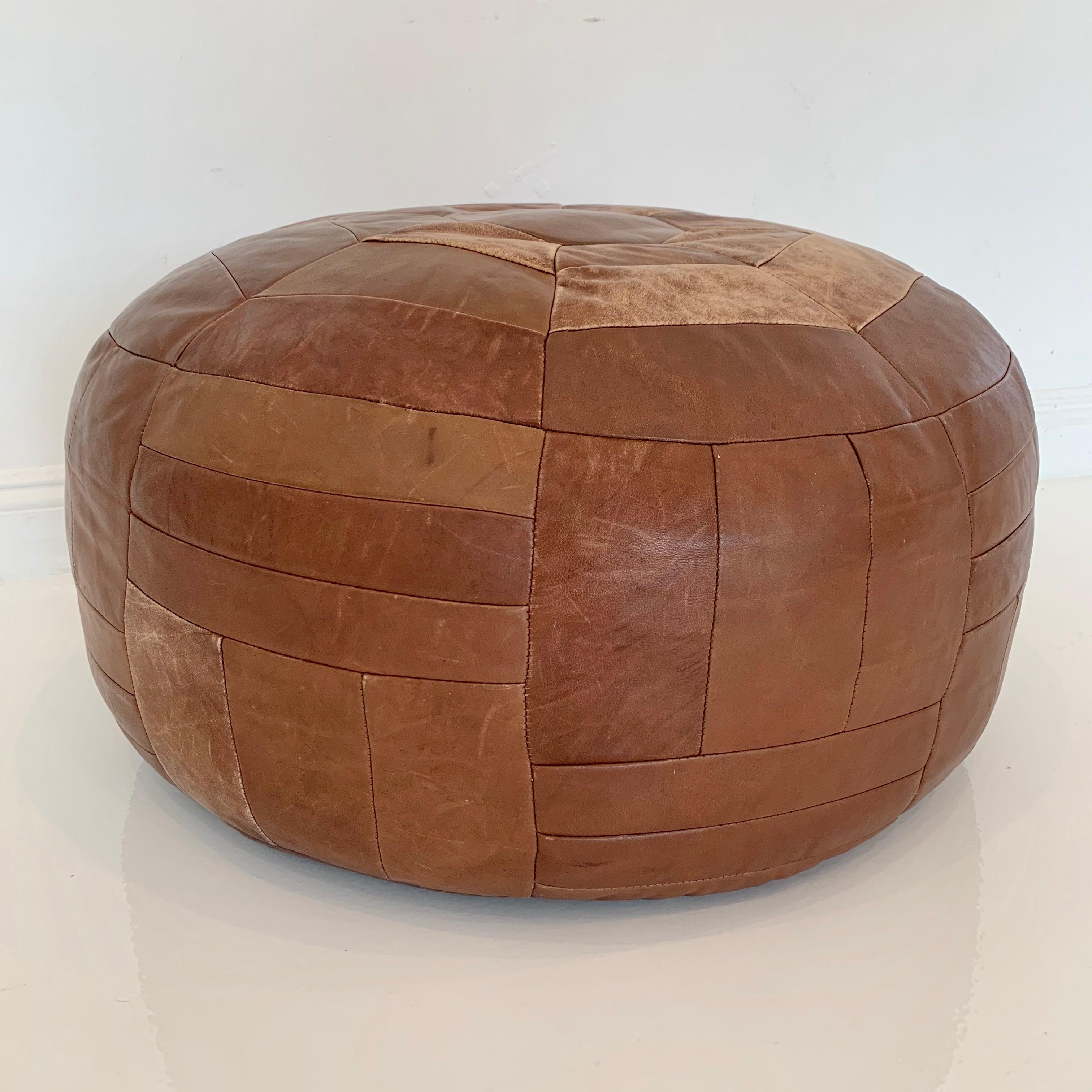 Fantastic giant leather patchwork ottoman by De Sede. Great coloring and patina to leather. Unusually large size. Very comfortable to sit on. Great vintage condition. 
 