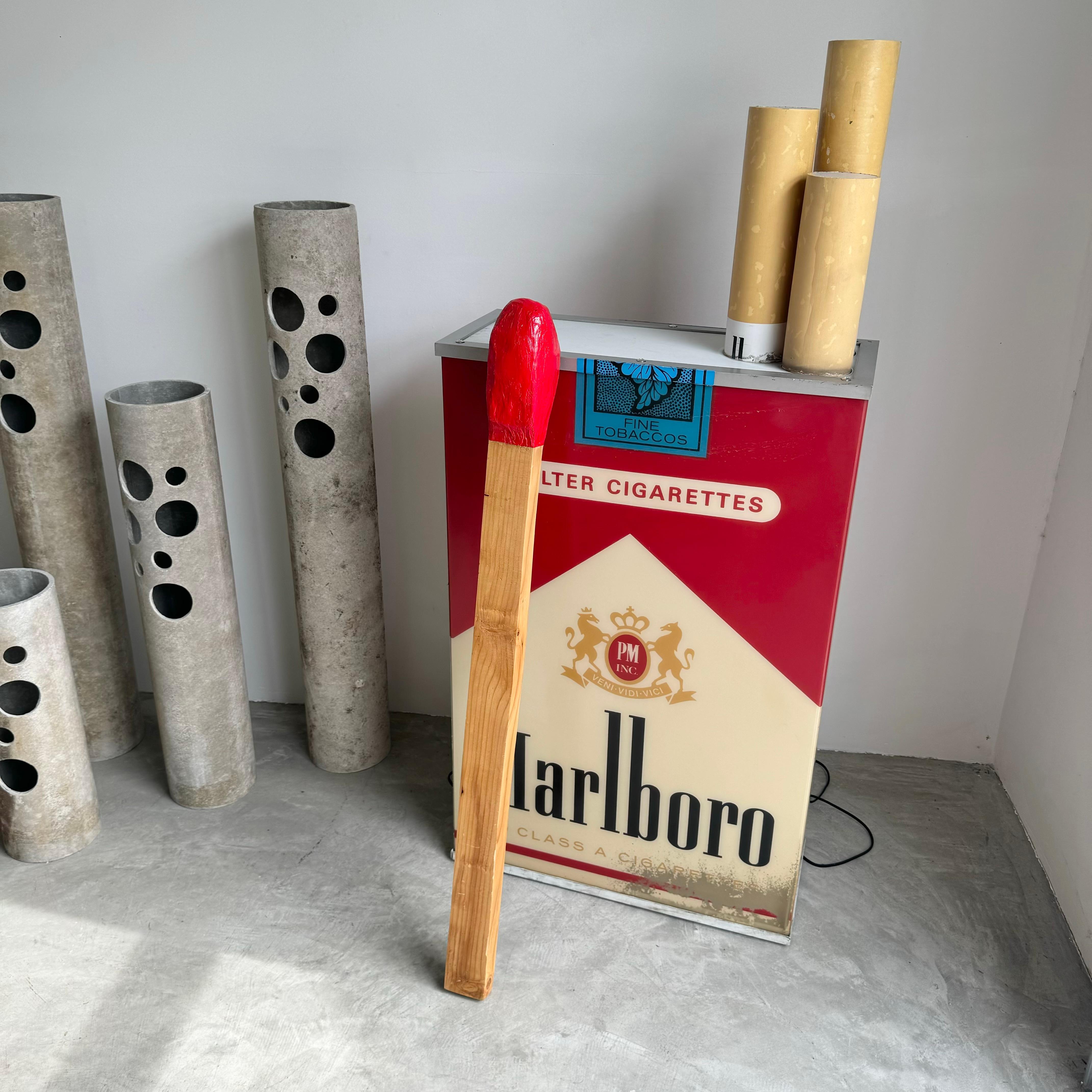 Pop art lovers will adore this oversized match. Great accent piece to add to any bookshelf or wall. Also looks great standing up against the wall. 

Solid and smooth wood makes up the lower half of the match, while a bright coat of firetruck red