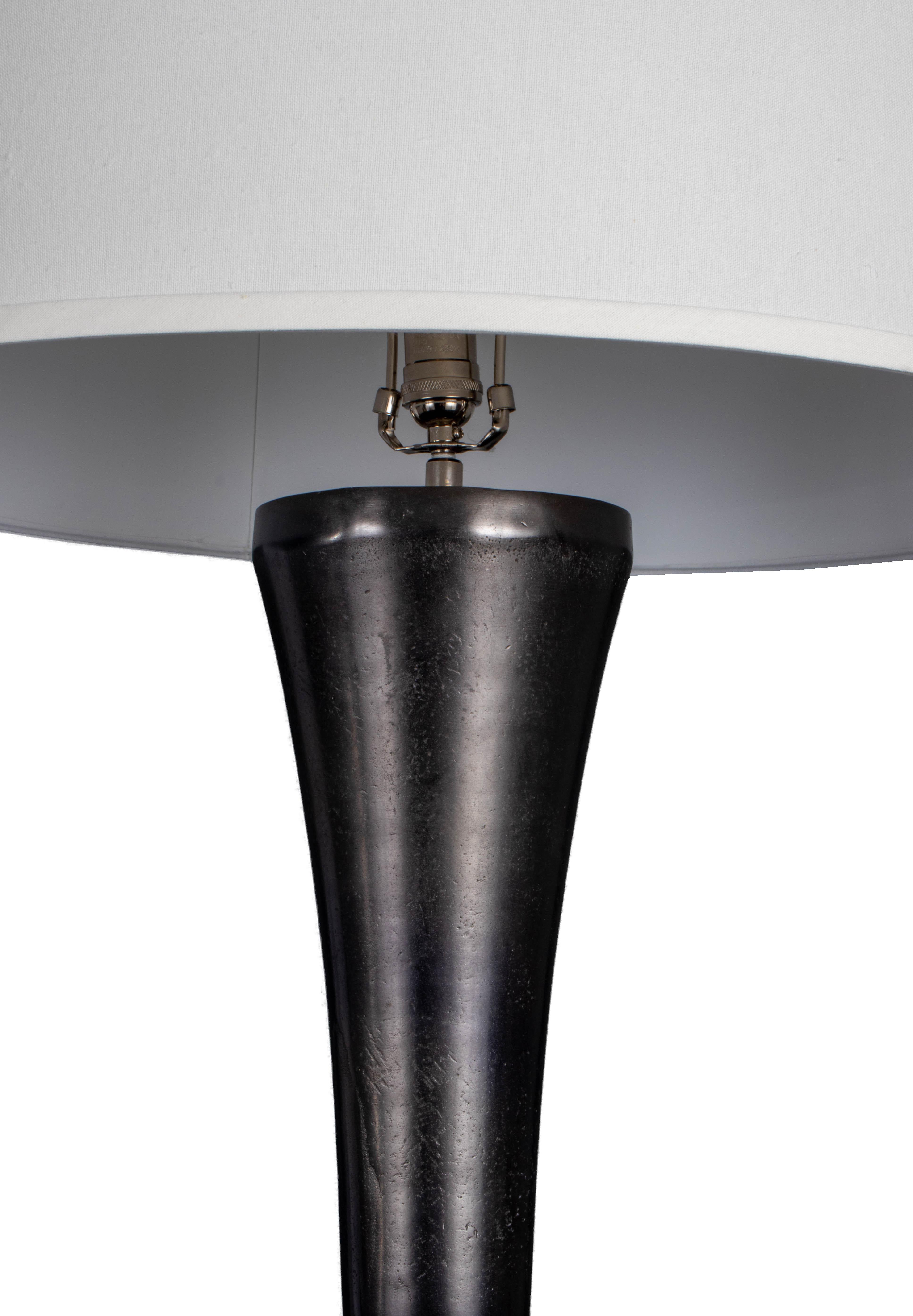 This cast aluminum table lamp is part of our Vision & Design collection that offers an organic, modern and contemporary aesthetic. Create a warm, inviting ambiance with this sleek and modern lamp. The cast aluminum table lamp offers an elegant
