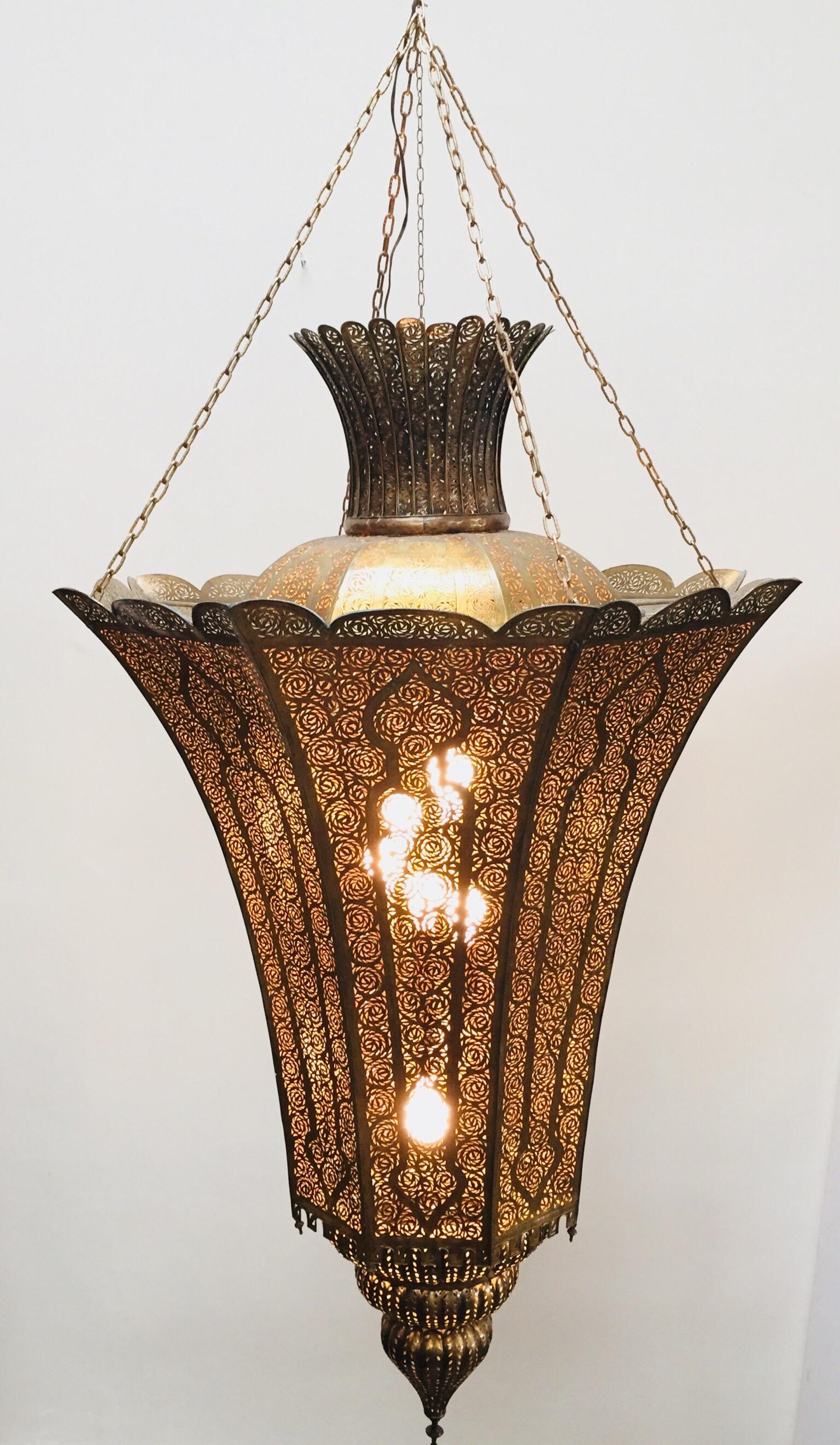 Oversized 7' high, spectacular, exquisite pierced brass Moorish Alhambra chandelier.
This exquisite light fixture is hand-crafted and chiselled with fine filigree Islamic designs.
Alberto Pinto Moorish style light fixture.
Moroccan lamp in brass