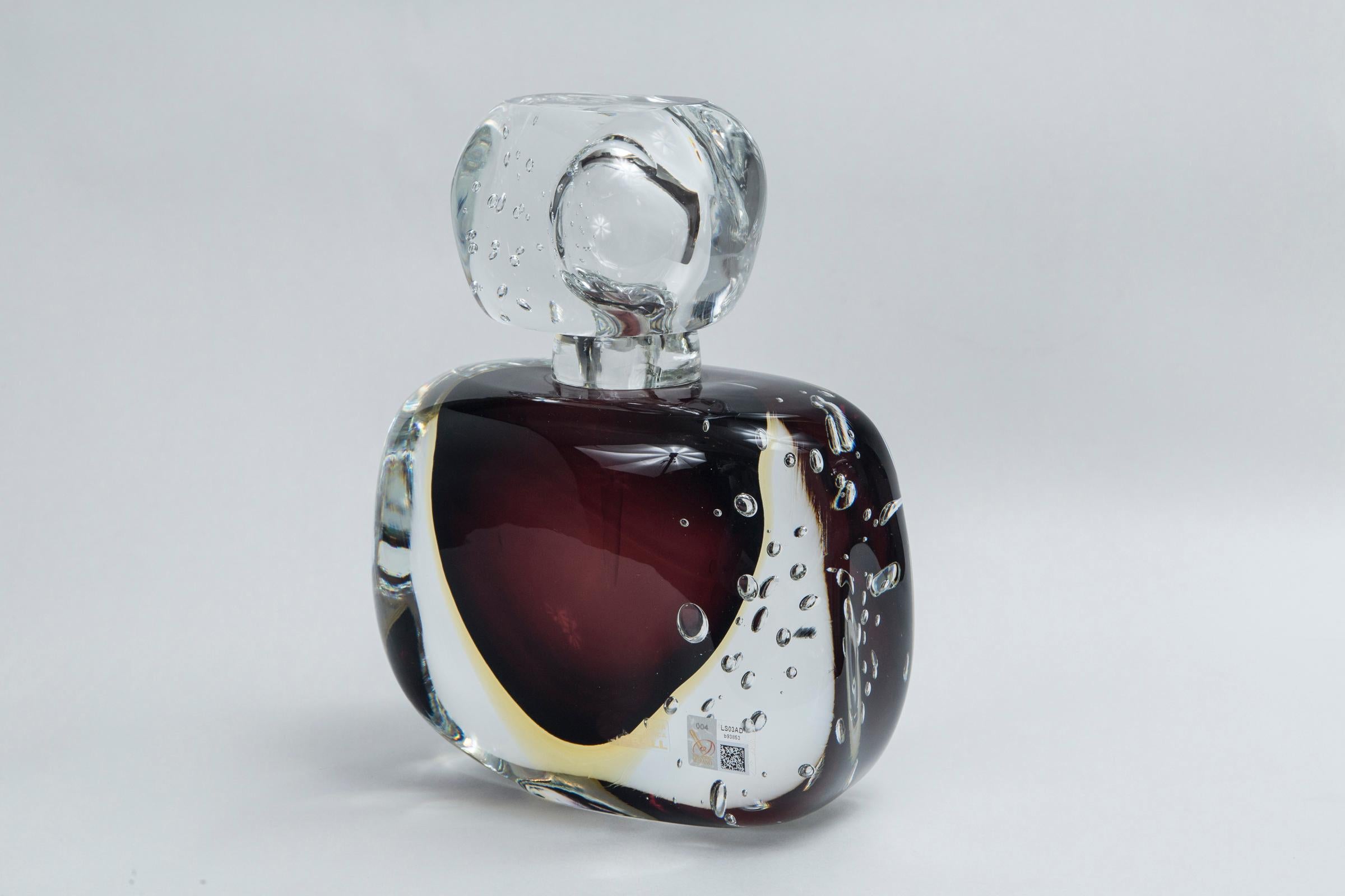 Wonderful one of a kind artisan blown irregular block-shaped bottle and dramatic stopper shown with large controlled bubbles and center floating orb shape in layers of plum and citron executed in the sommerso technique, signed by the artist,