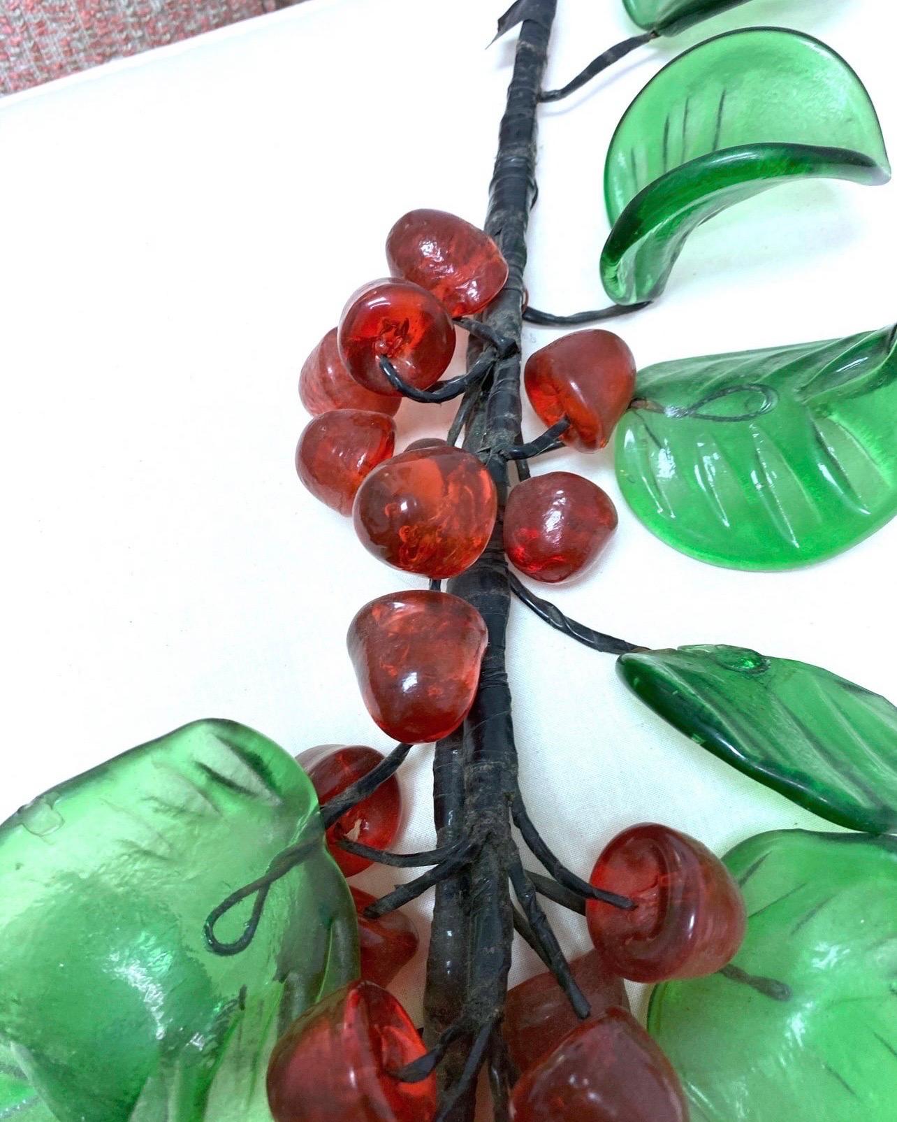 This large stem with glass cherries has vibrant red and green, looks good all year but Would make an excellent table top decor for the holiday season.    The stem is flexible so you can spread this out as you like.  
Please see all pictures because