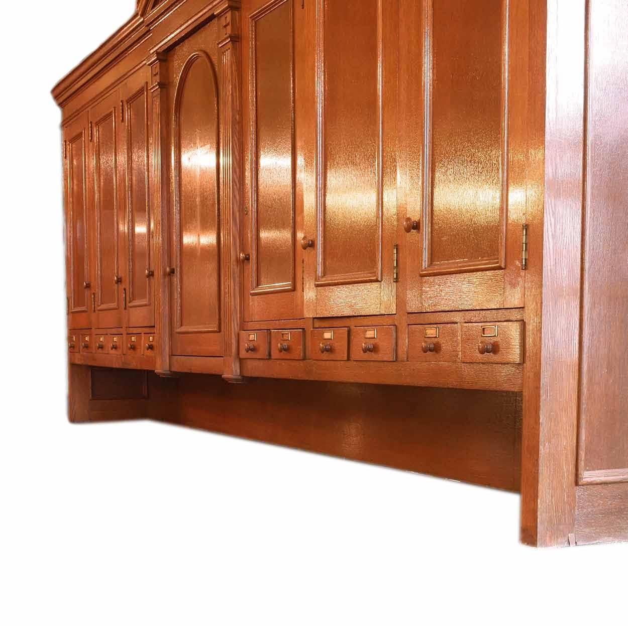 This solid golden oak turn of the 1900s vestment top cabinet is humongous. The cabinet has a single center door (20