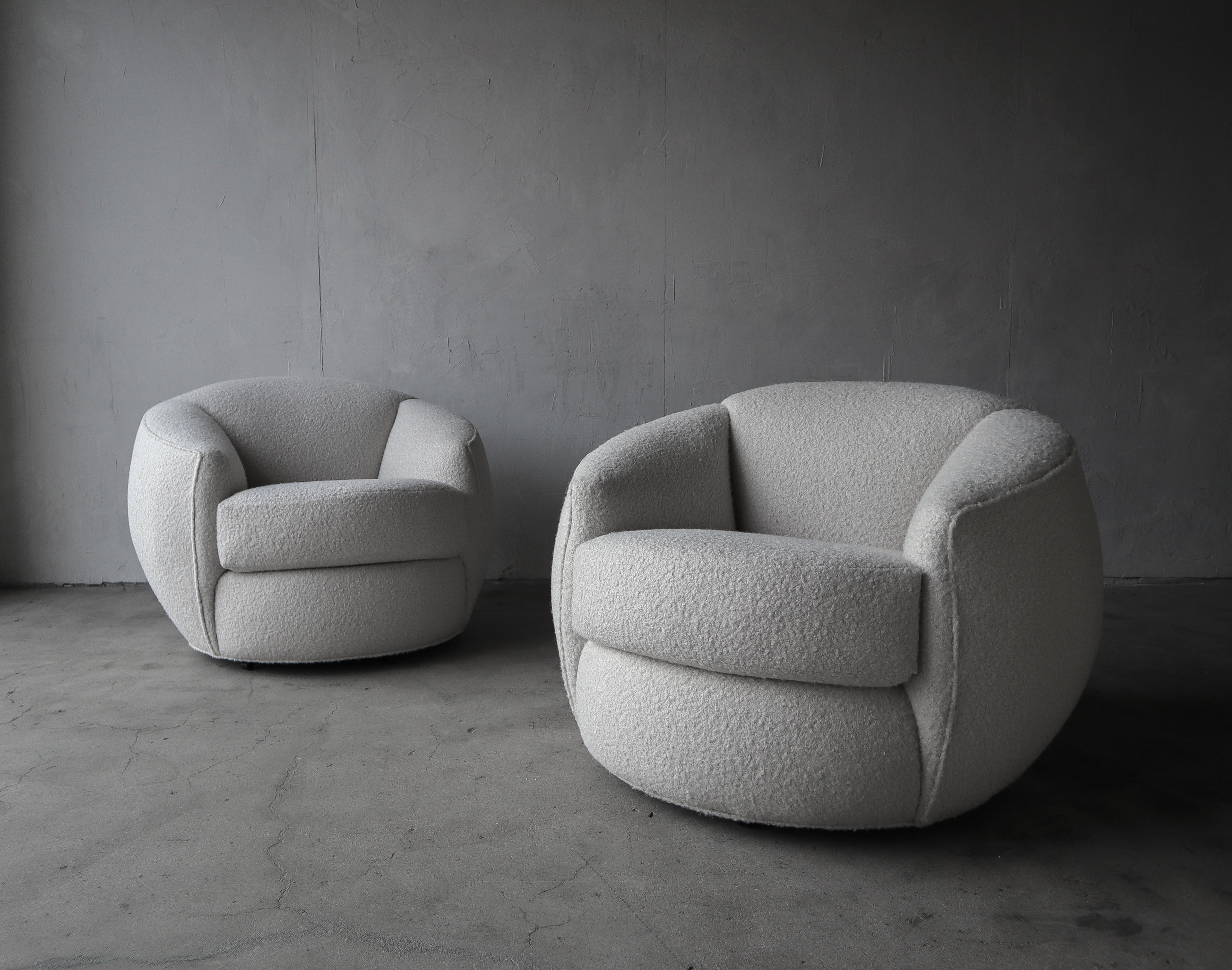 Pictures do not do these justice. This is a truly gorgeous pair of Post Modern ball chairs that have been modernized with all new off white boucle fabric and new foam. They are quite large however the femininity of their shape adds to their appeal,