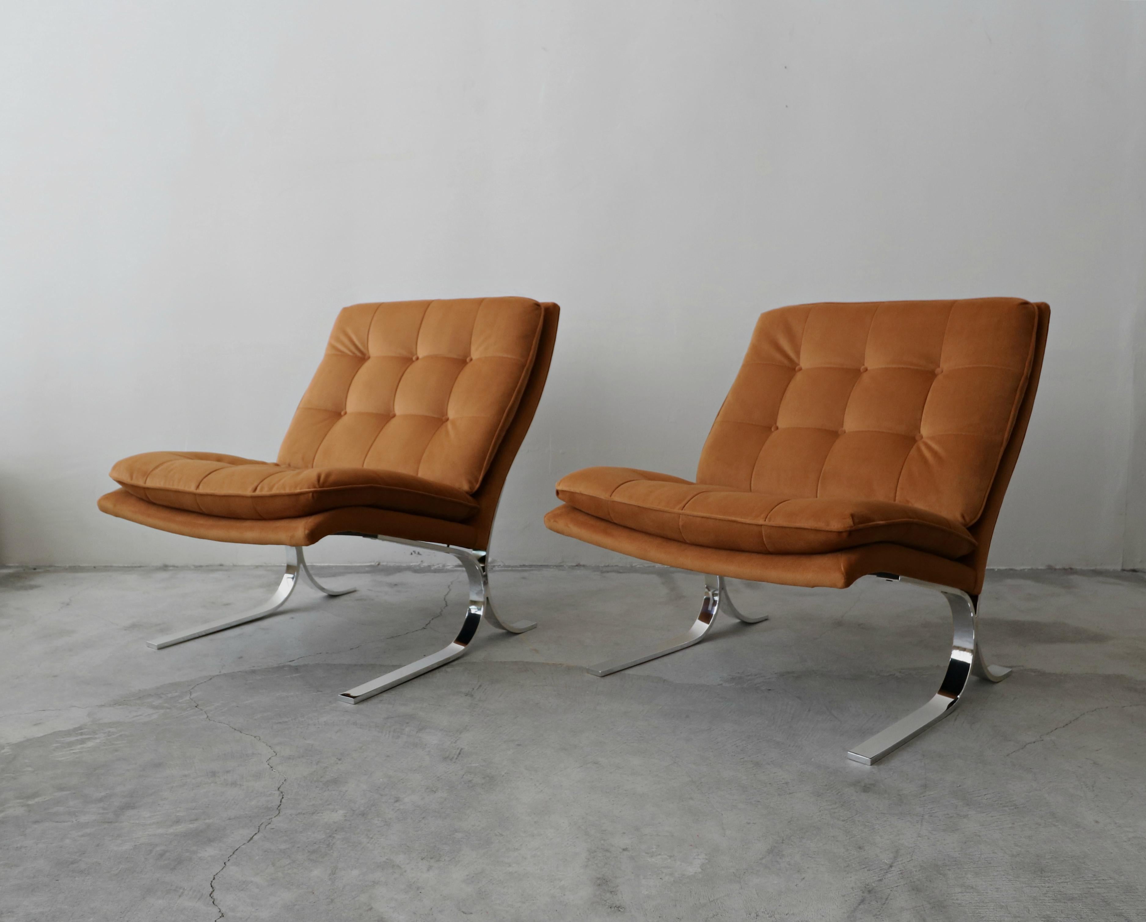 Beautiful pair of midcentury chrome slipper chairs. Chairs are reminiscent of the iconic Barcelona chair. These chairs are substantial in size and have the most beautiful profile.

They have been professionally reupholstered with all new foam and
