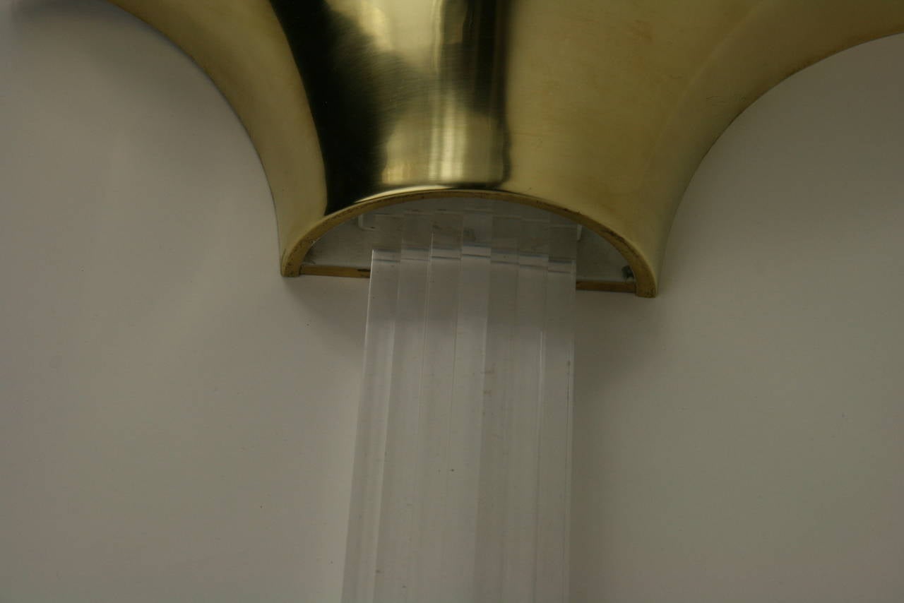 Pair of oversized brass and acrylic sconces. Brass wall washer has one porcelain socket takes 100 watt Edison base bulb.

Priced per pair.