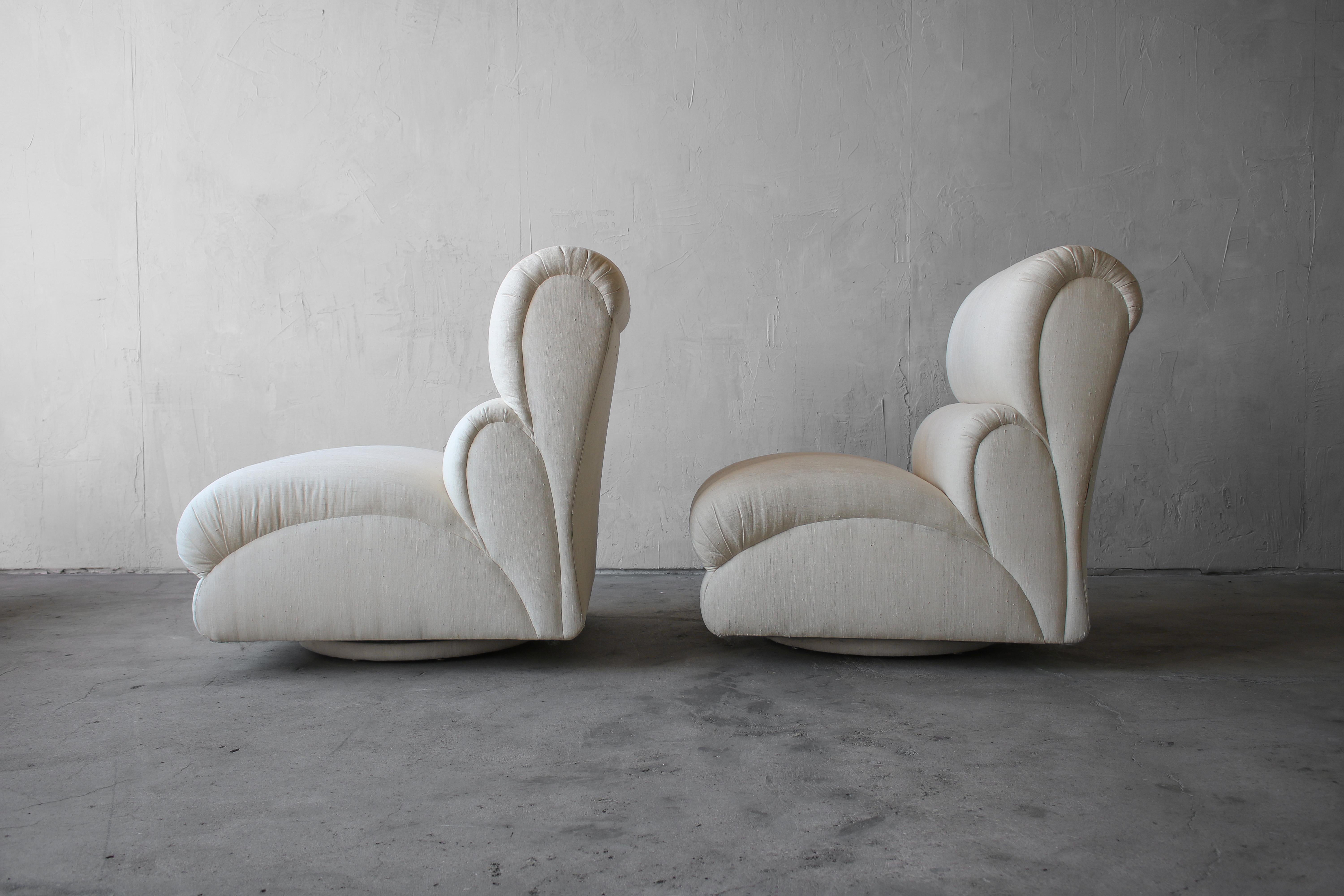 Incredible and large pair of post modern rocking swivel slipper chairs on round plinth bases. These beauties truly have lines and curves worth coveting. A real gorgeous pair of slipper chairs. 

Chairs are left as found so that they can be