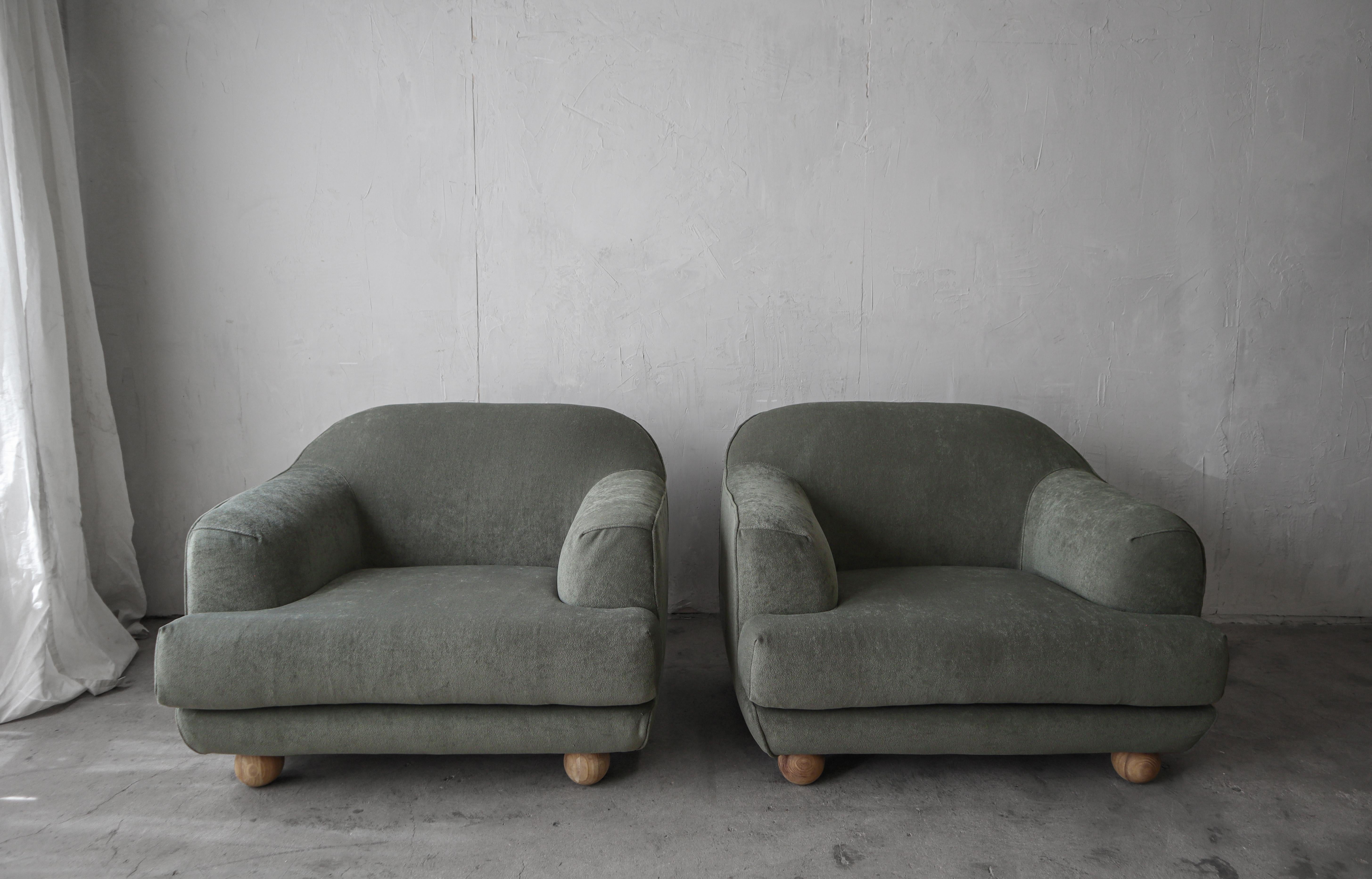 Incredible and large, pair of Post Modern lounge chairs. The lines give them a very feminine and Art Nouveau feel.  They channel designs similar to Jean Royere.  I love their ball feet.

The chairs are comfortable and structurally sound. The sage