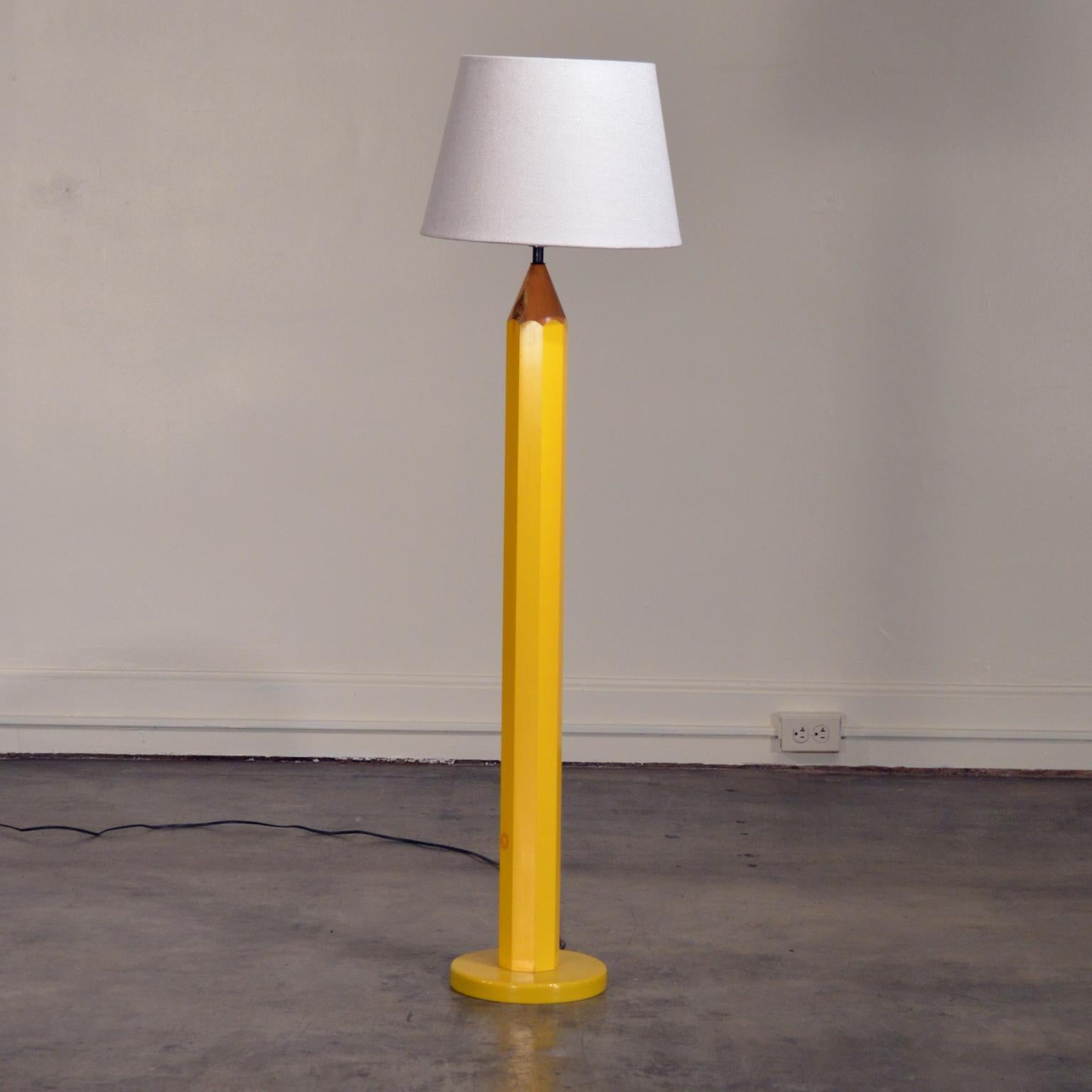 This playful Postmodern floor lamp is designed to resemble pencil with tip pointed upward. Painted pine wood, resembles a standard No. 2 pencil.

Marked as created by Lightolier with a sticker on the lamp socket. Height to top of socket is 45