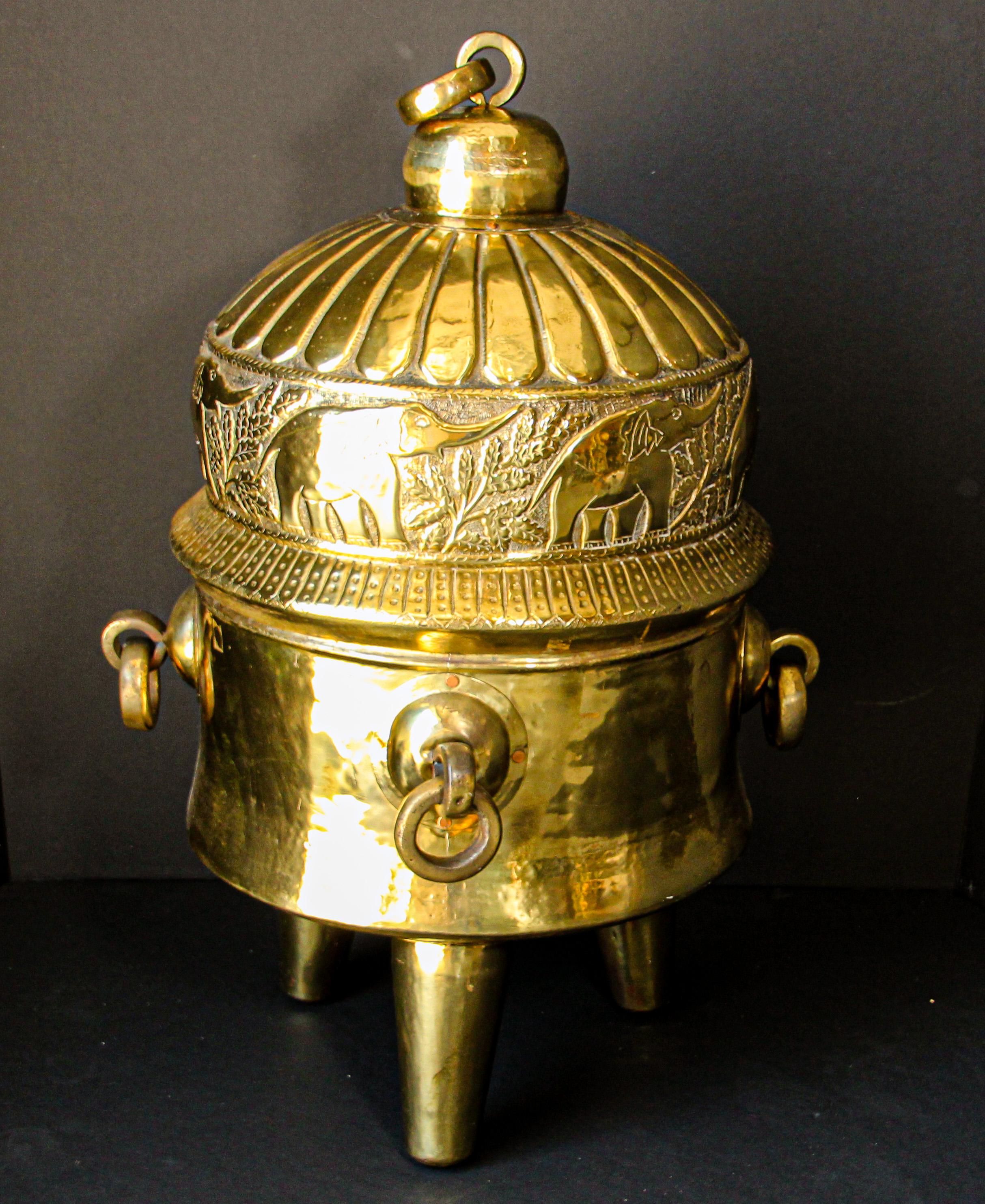 Oversized gigantic antique polished brass and copper Asian container for precious textiles, clothes and jewellery.
This vessel formed an important part of the dowry given to a kathi bride.
Museum quality piece on tripod, with the cover hand carved