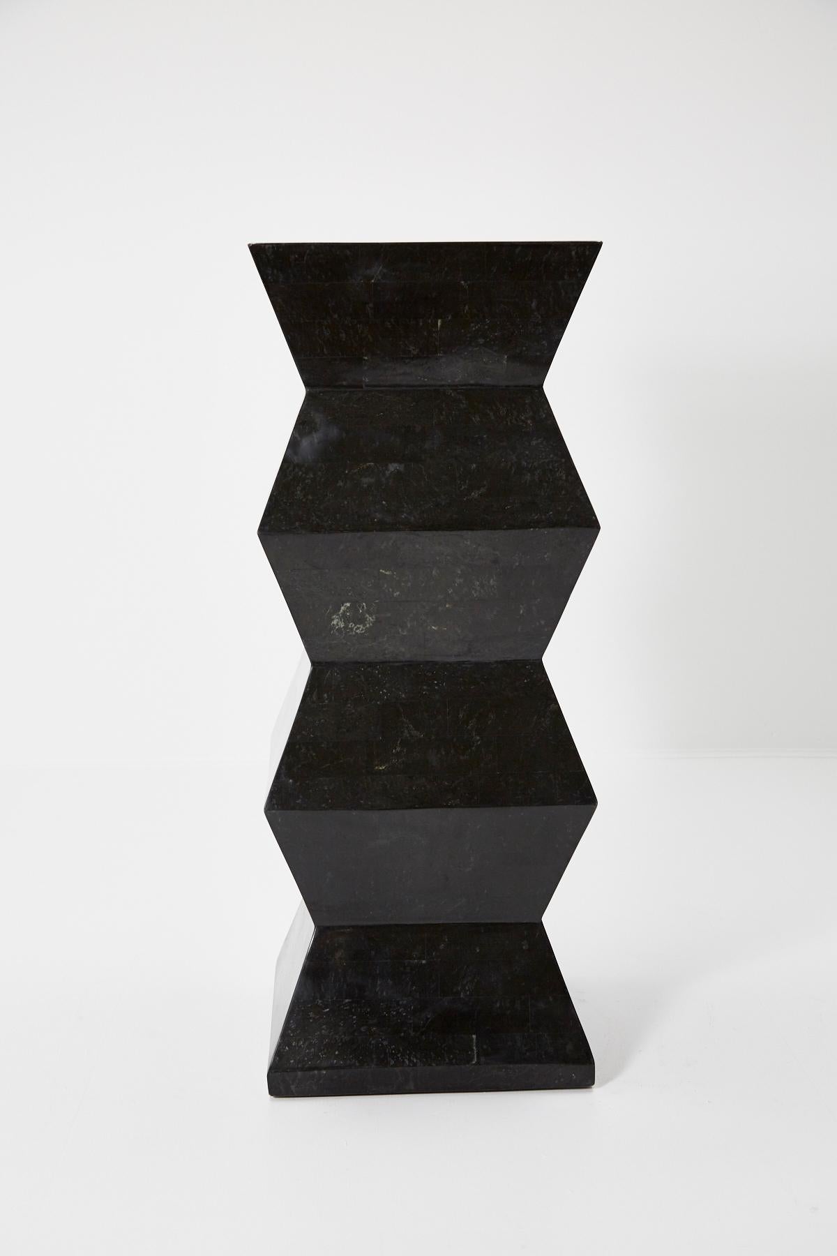 Black tessellated stone pedestal with chiseled accordion shape. Great oversized scale at 46 x 18 x 18 in. 

