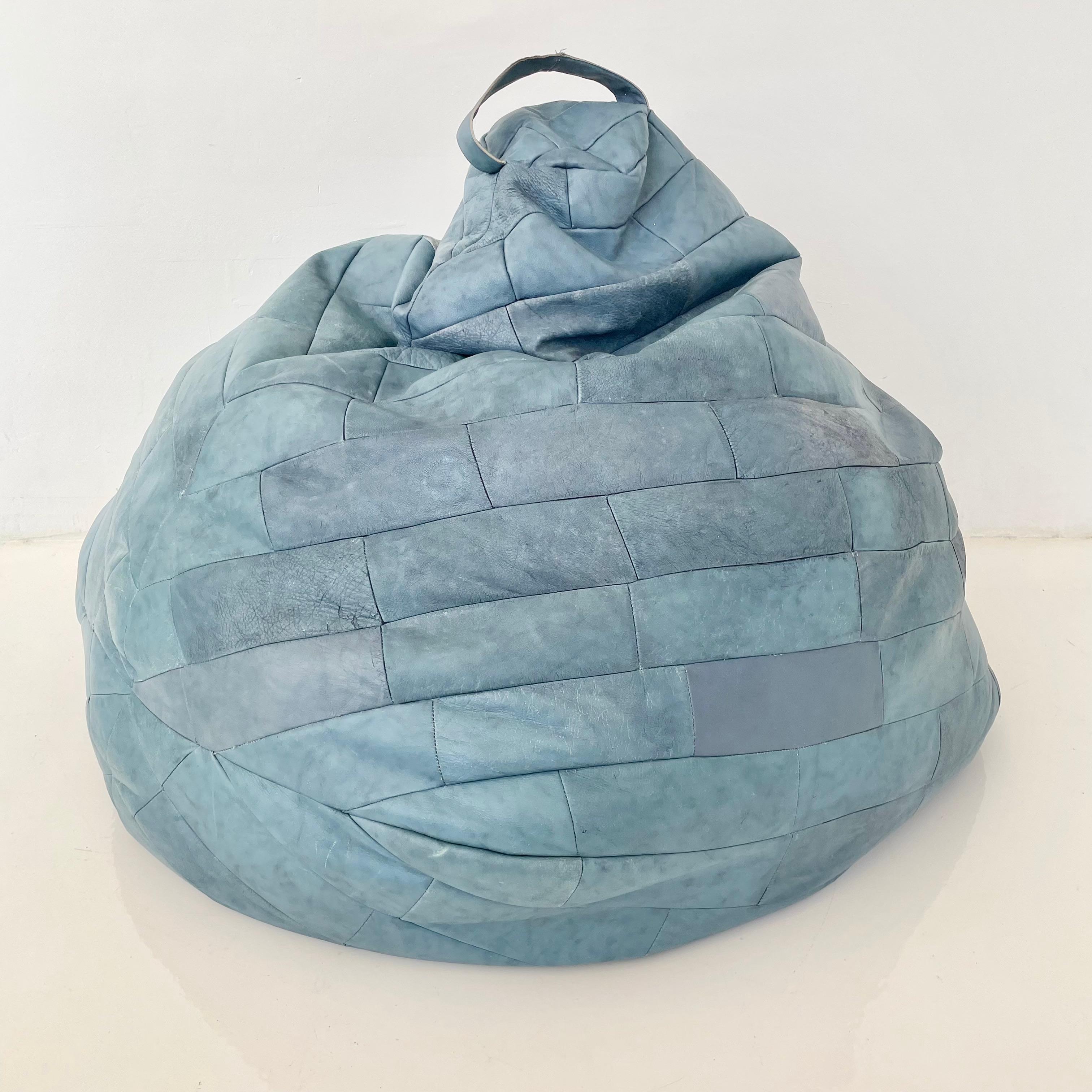 Gorgeous oversized 70s powder blue leather patchwork bean bag by De Sede. Great coloring and patina to leather. Good vintage condition. Wear to leather as shown. Extremely comfortable. Fun accent piece.

Newly stuffed with foam beads and slip