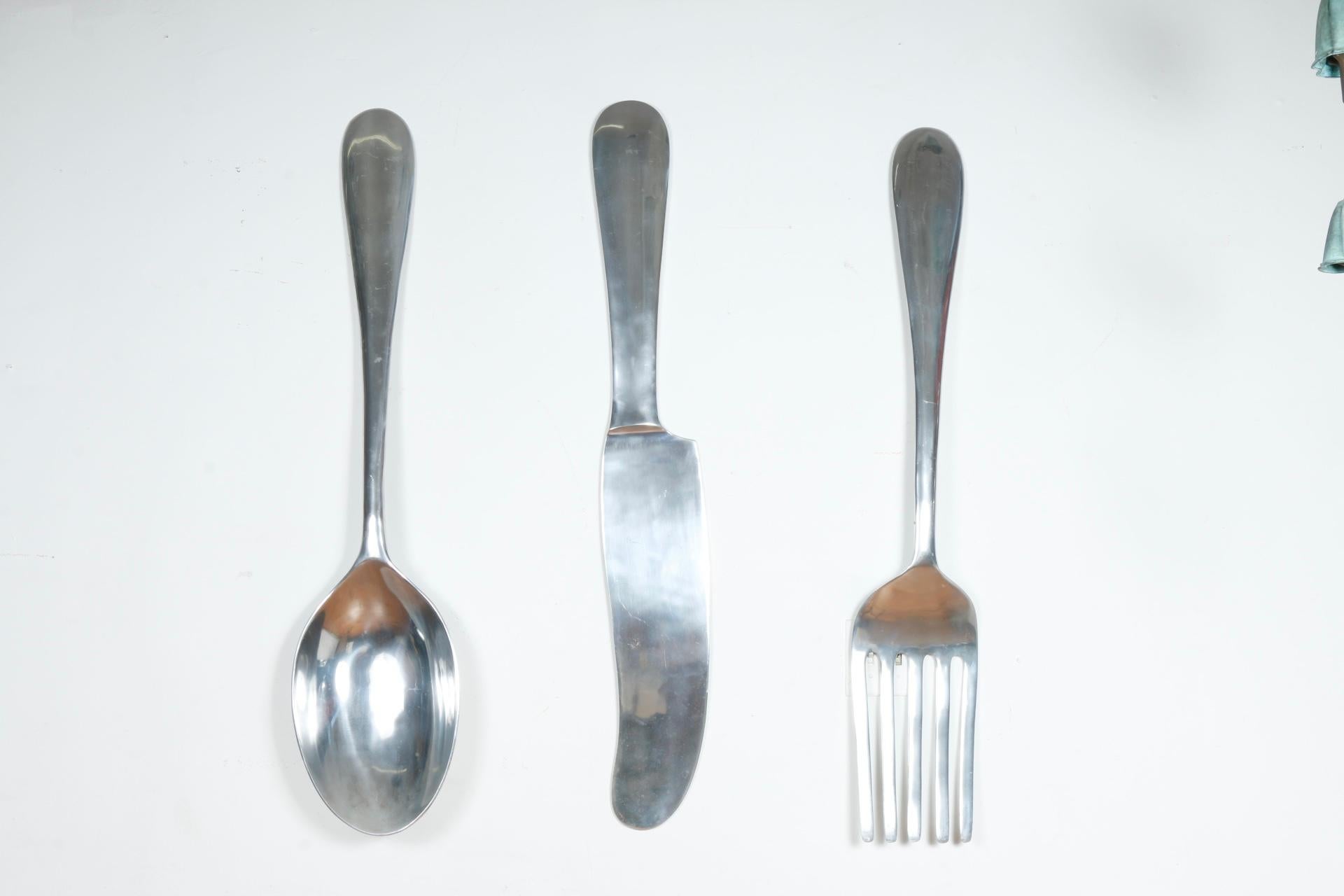 Vintage aluminum set of 3 knife, fork and spoon large wall decor. Has a hook in the top back so they can hang. Well kept with signs of age and use.