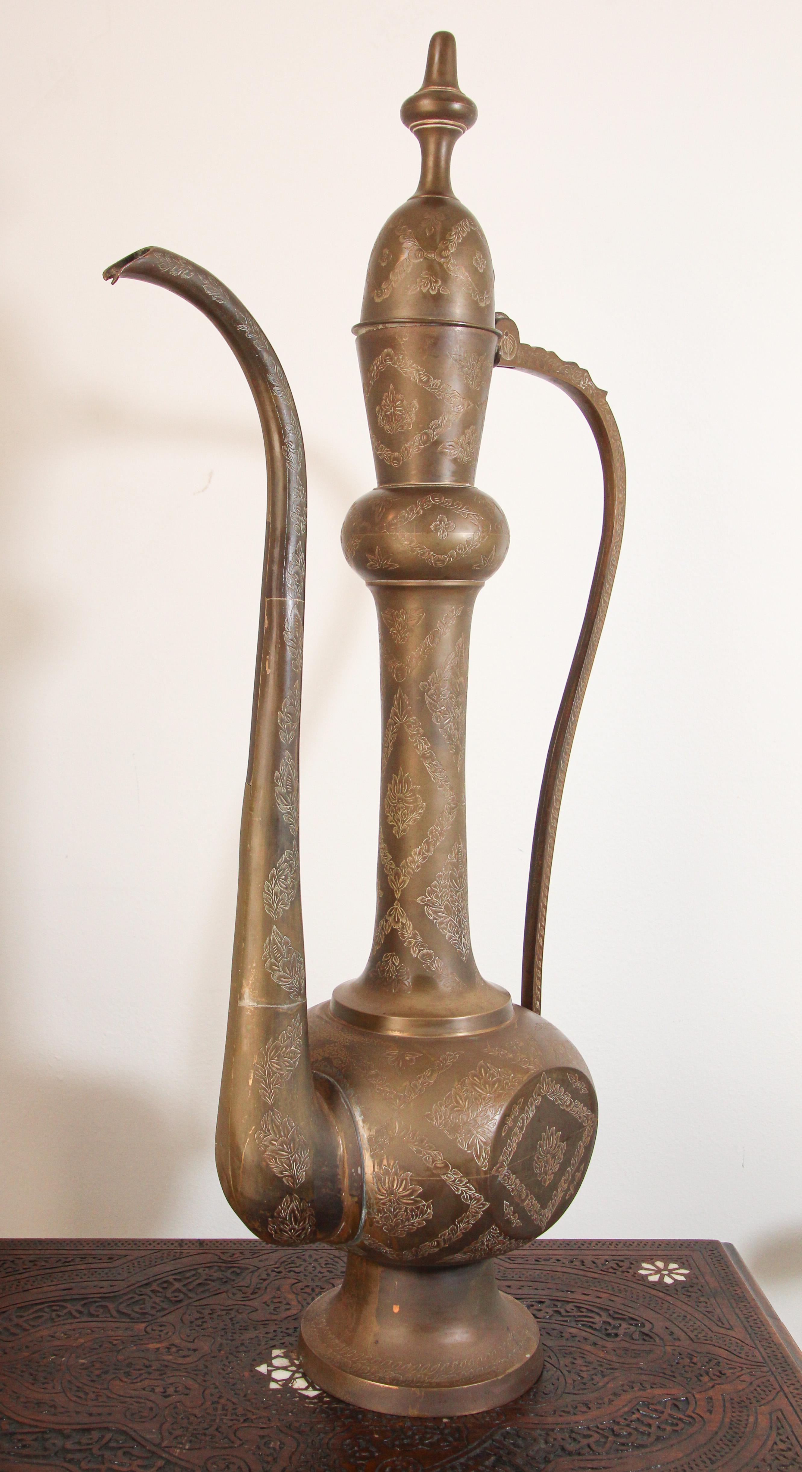 Oversized 3 feet tall Middle Eastern, Mughal Indian style brass decorative ewer.
Very decorative handcrafted brass Moorish Arabian style coffee pot, wine or water pitcher.
Hand-hammered and etched brass with floral intricate Moorish Islamic