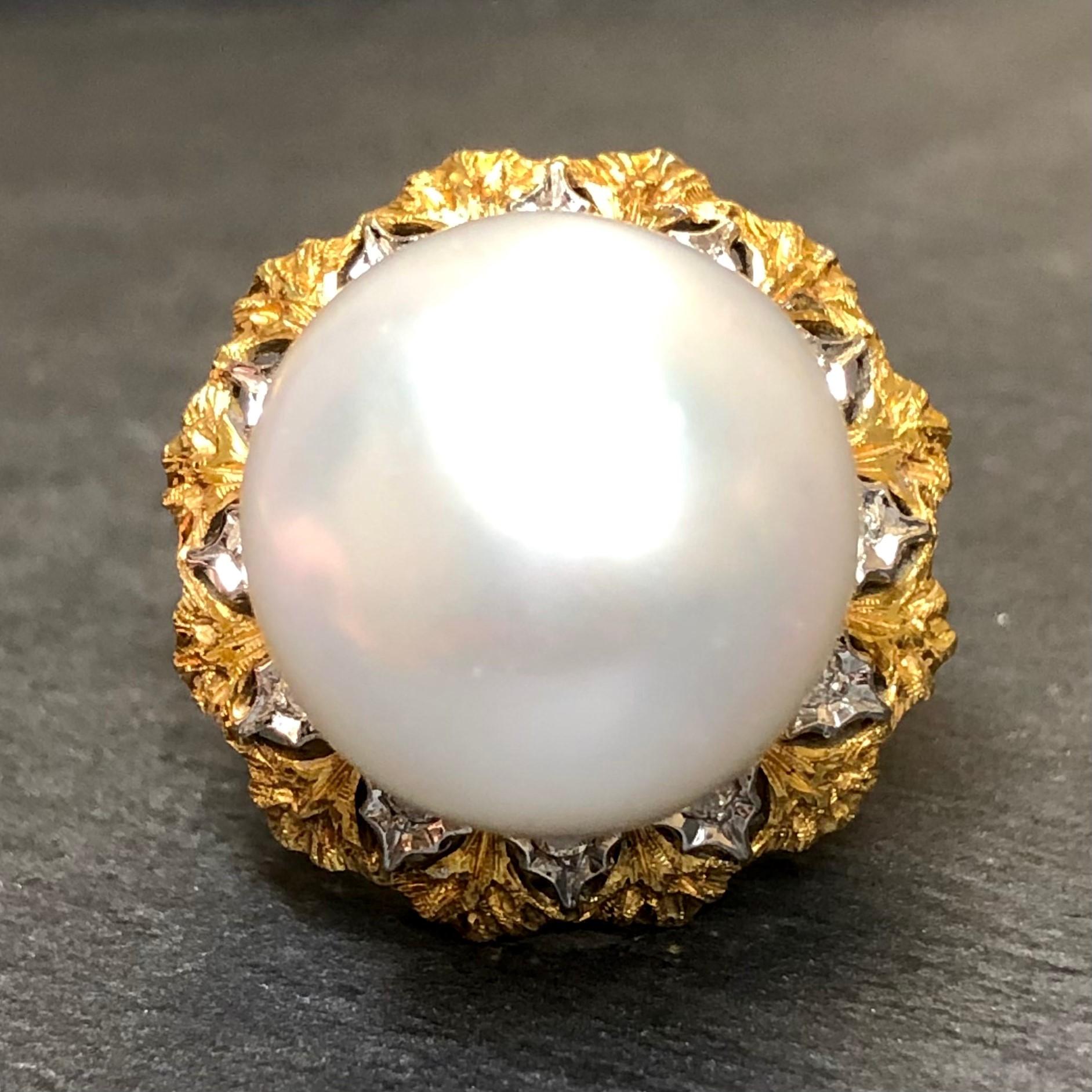 An incredible cocktail ring with the focal point being a very large 17mm cream-colored South Sea pearl with very minor surface blemishes as well as approximately .33cttw in G-H color Vs clarity round diamonds. The textural nature of this piece is