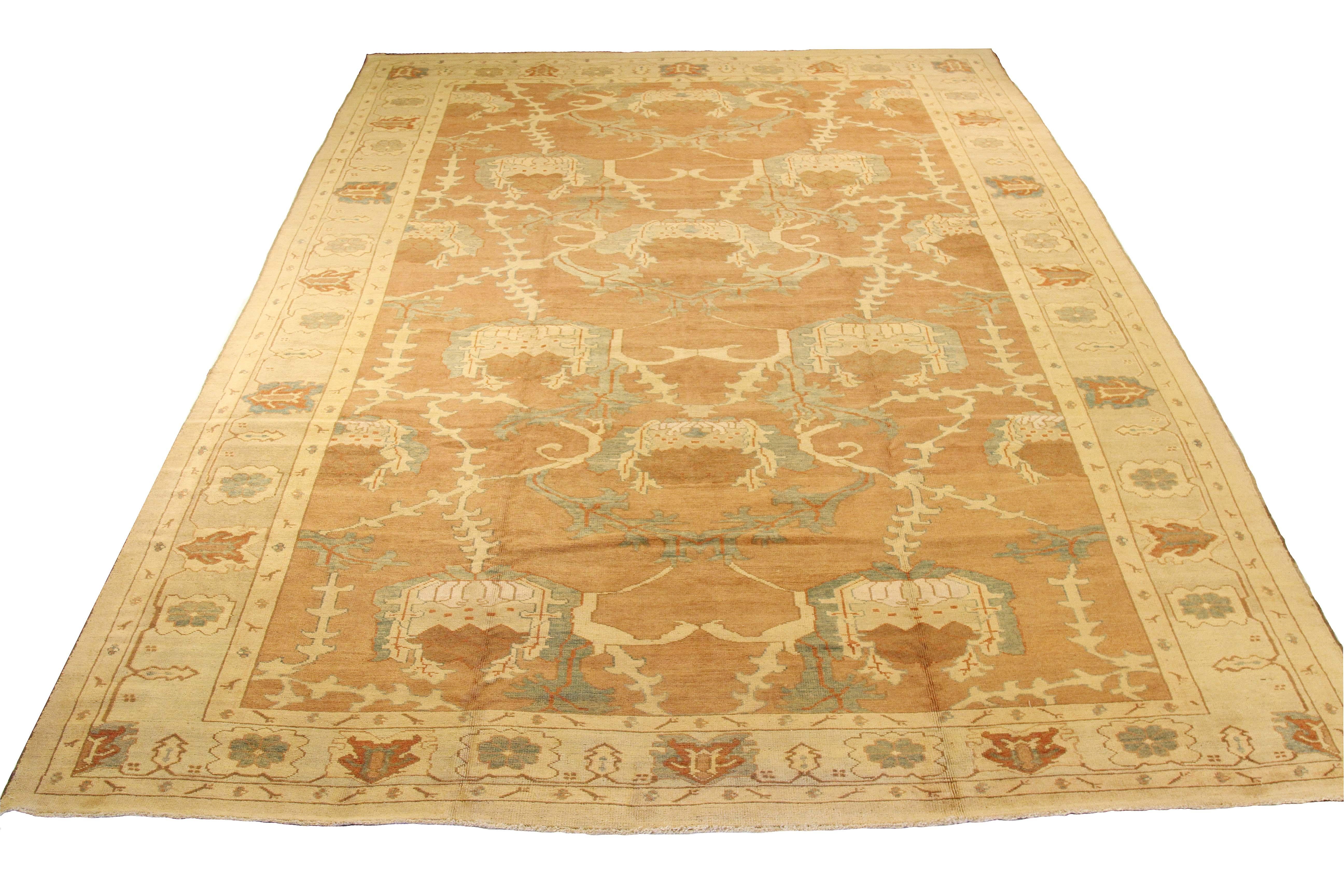 Large and oversized handmade Turkish rug from high-quality sheep’s wool and colored with eco-friendly vegetable dyes that are proven safe for humans and pets alike. It’s a Donegal design showcasing a brown and ivory field with gray and red botanical