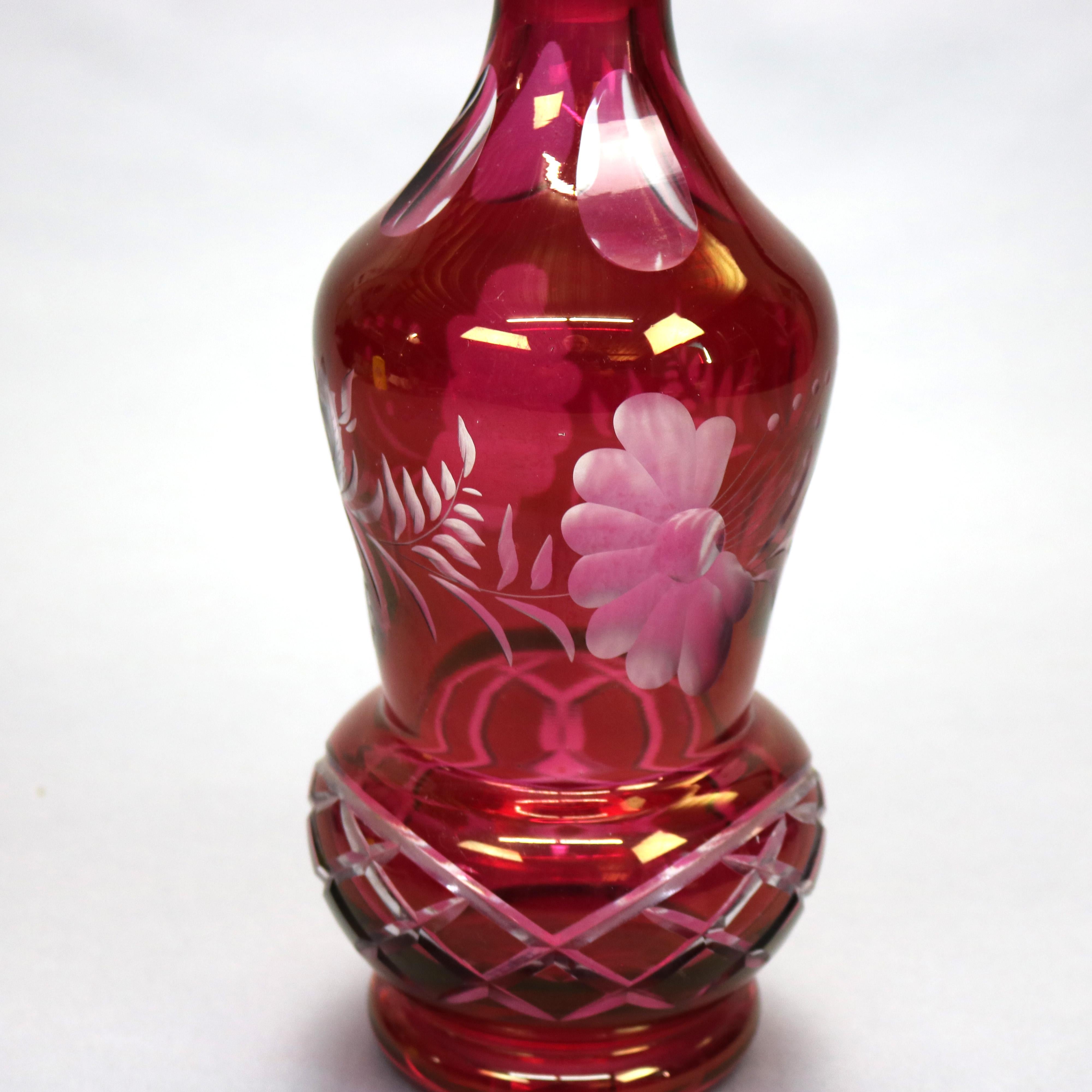 An antique and large Victorian Bohemian decanter offers cranberry glass construction with foliate and thumb print cut-to-clear decoration, c1890

Measures: 16.75